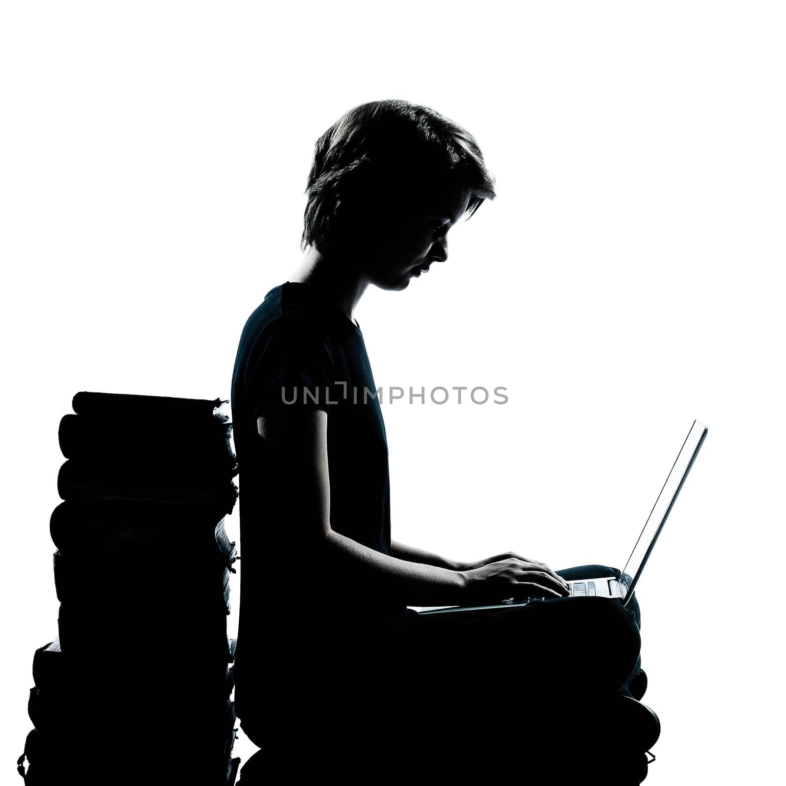 one caucasian young teenager silhouette boy or girl studying with computer computing laptop in studio cut out isolated on white background