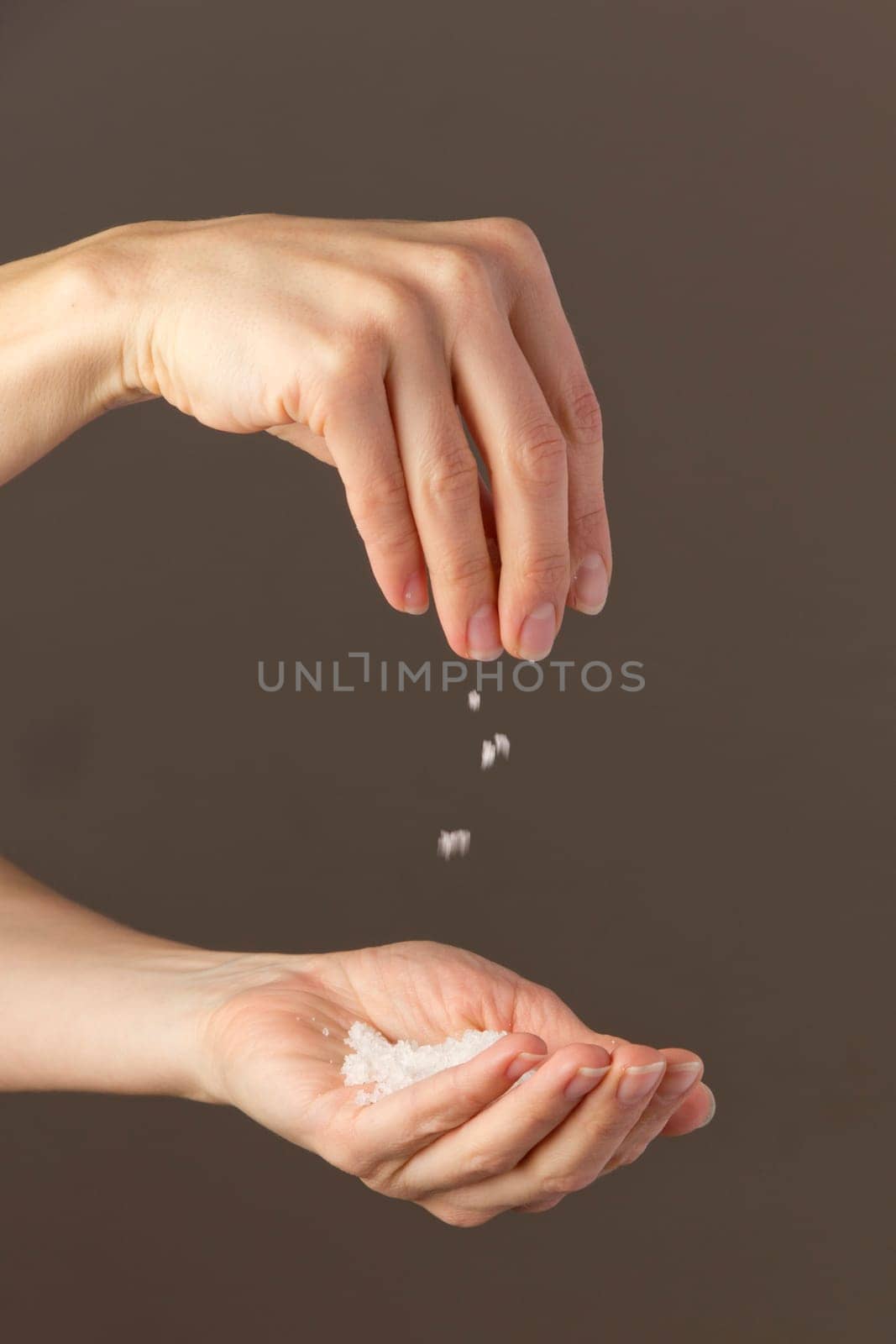 Hands sprinkle salt