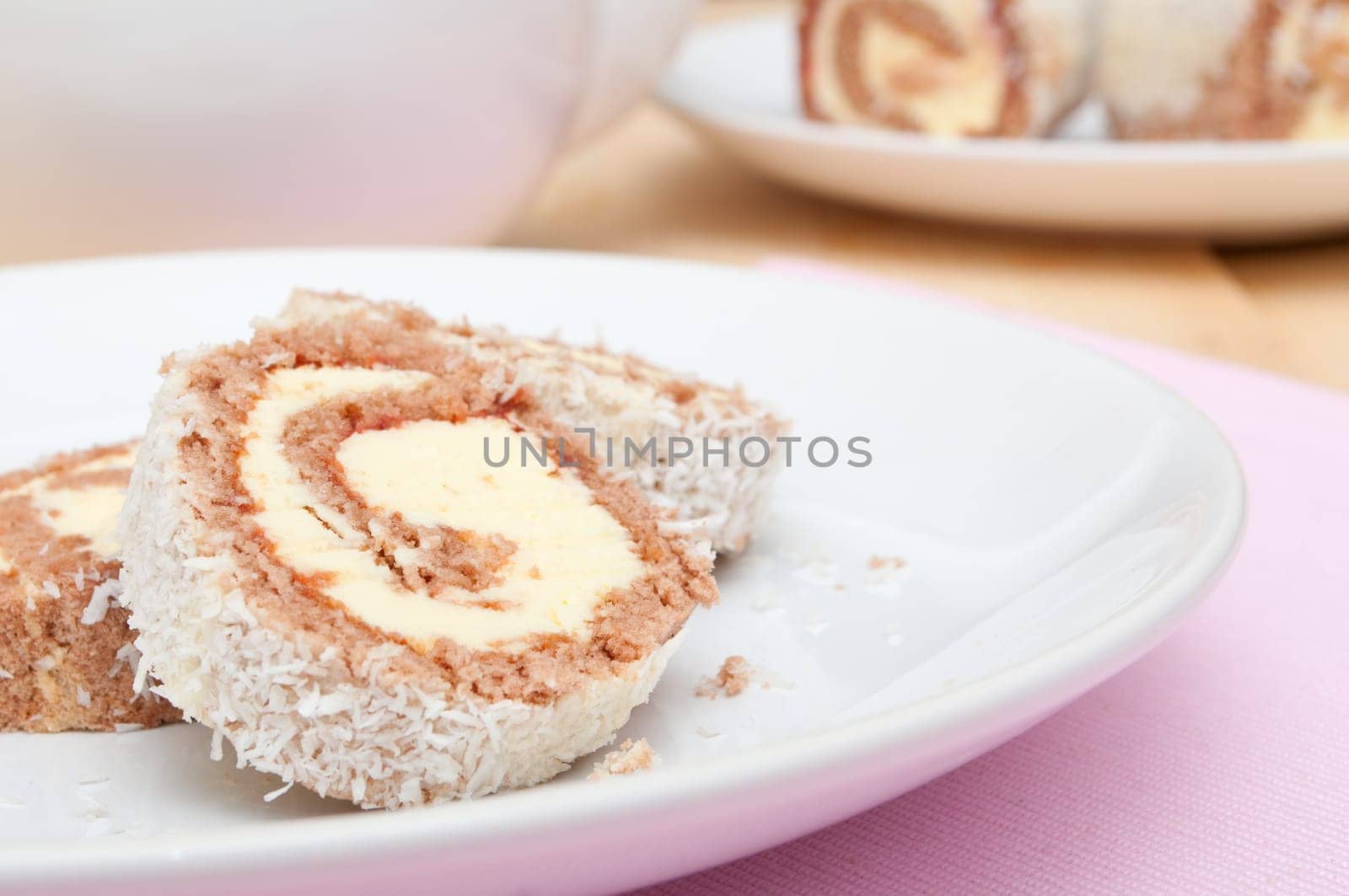 Swiss Sponge Roll Dessert With Cream on White Plate - Shallow Depth of Field
