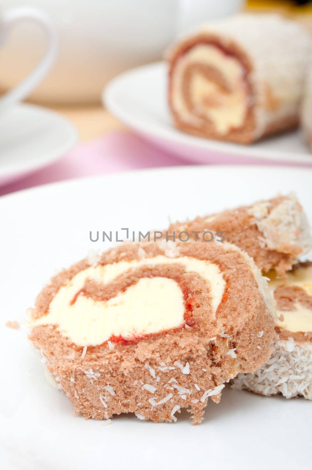 Swiss Sponge Roll Dessert With Cream on White Plate - Shallow Depth of Field