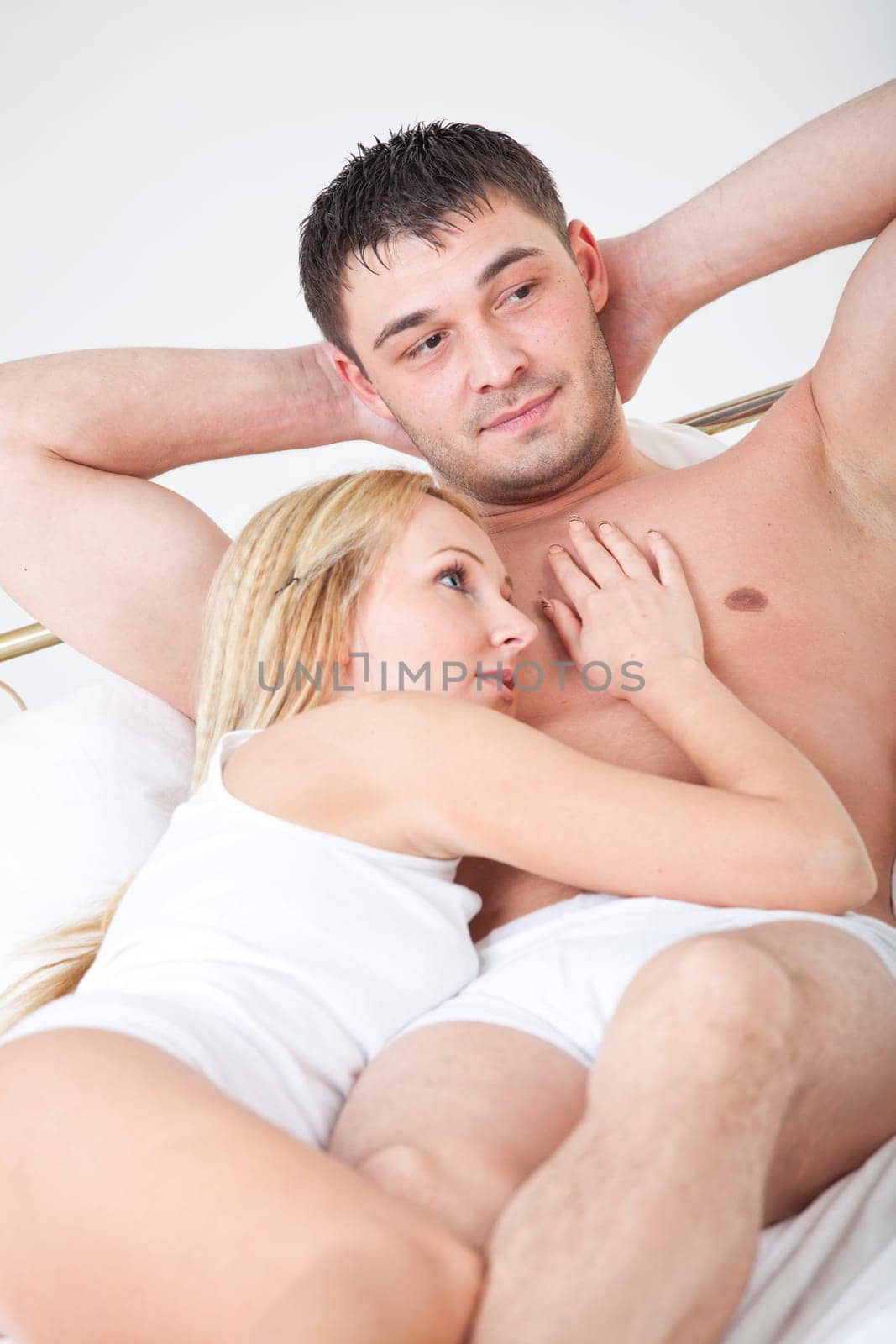 Young couple in nightwear lying in bed