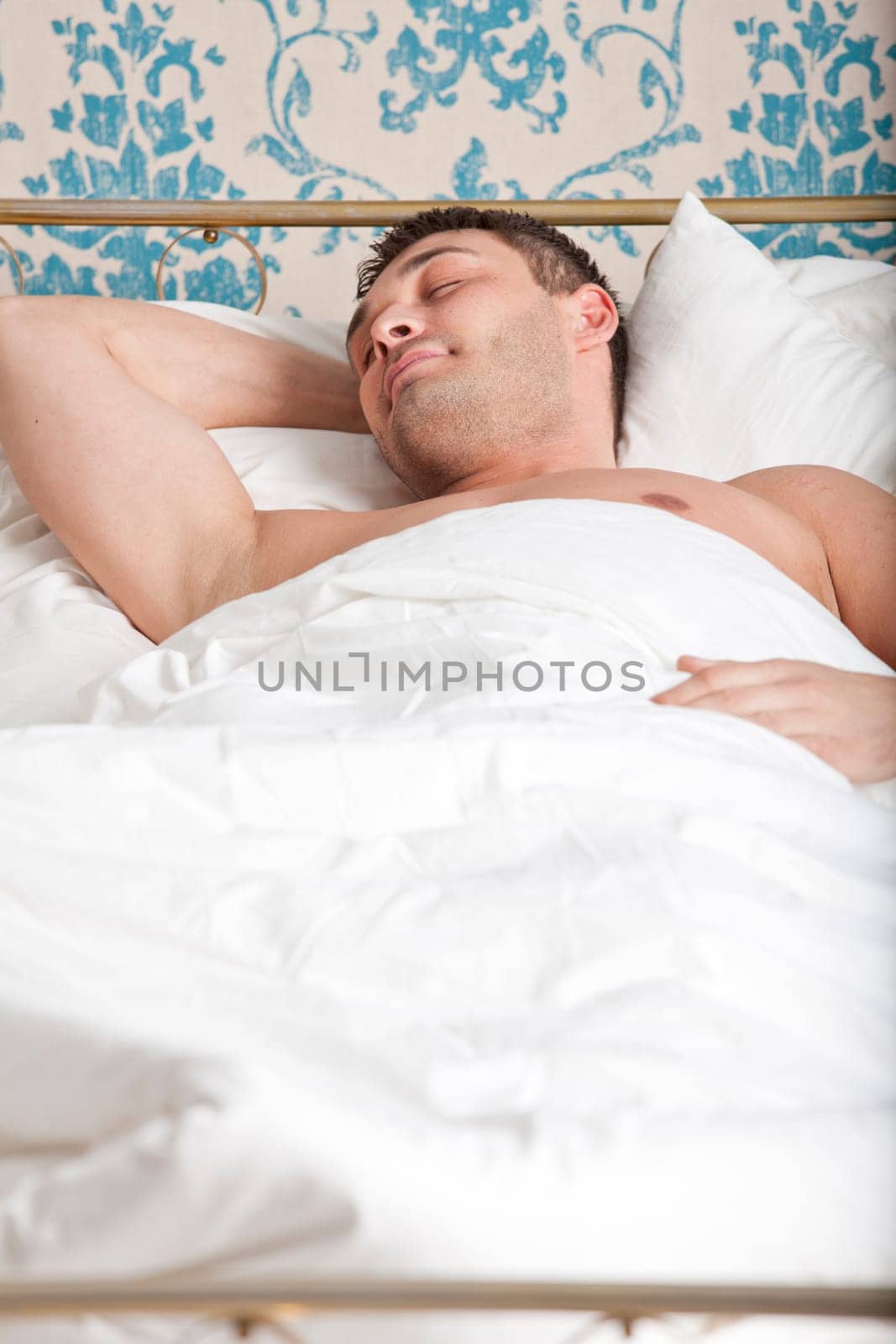 portrait of a man sleeping in bed