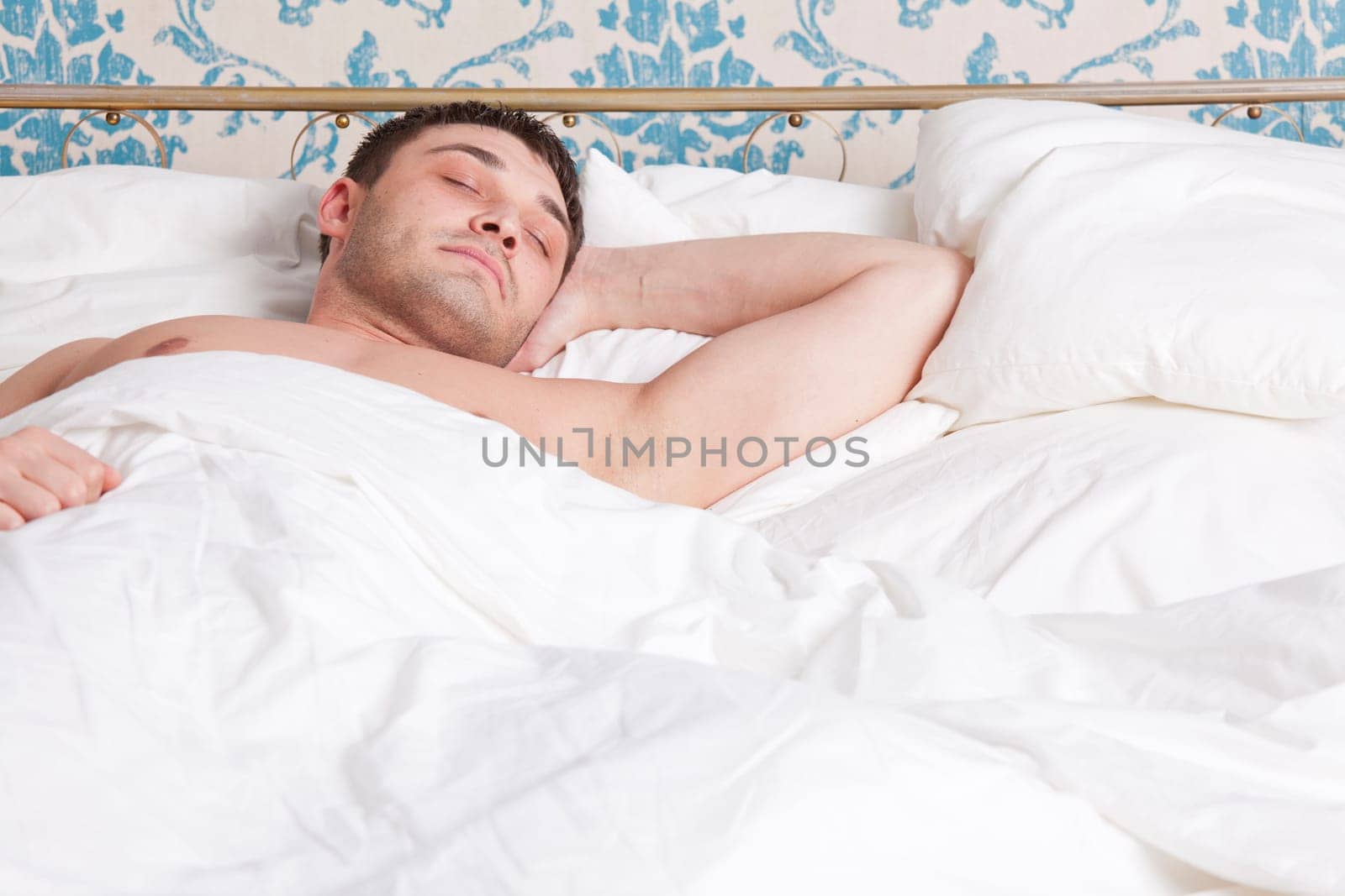 man sleeping alone in bed