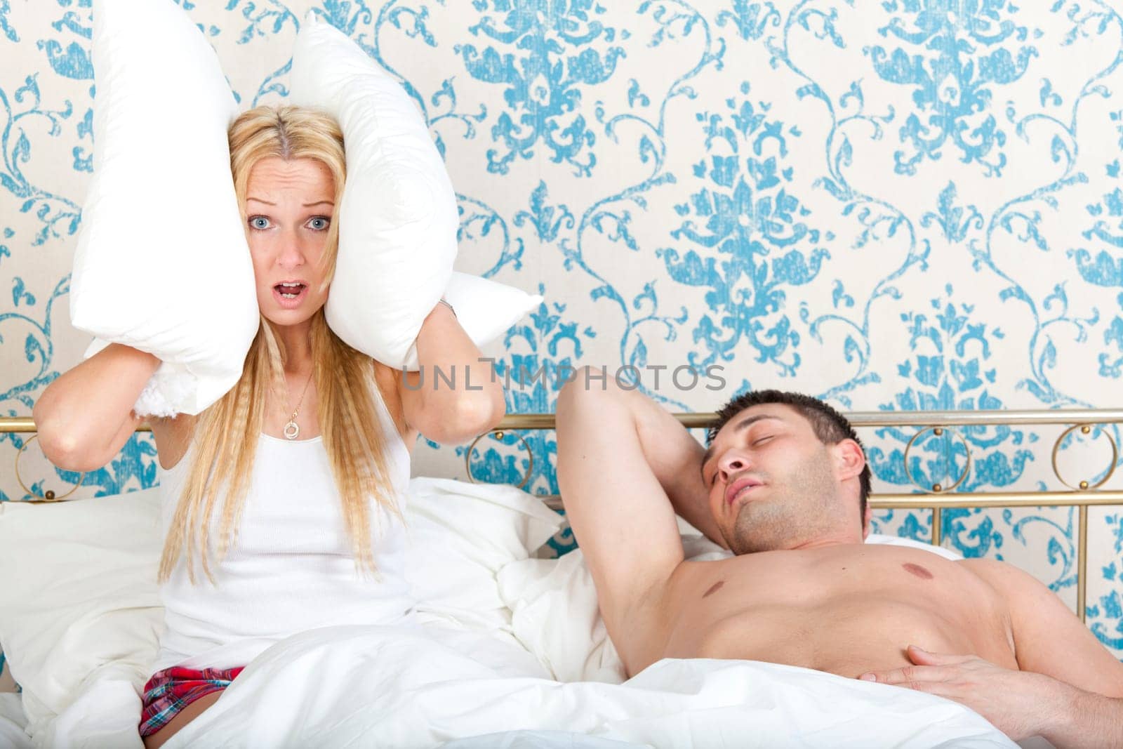 Woman trying to sleep while man snoring