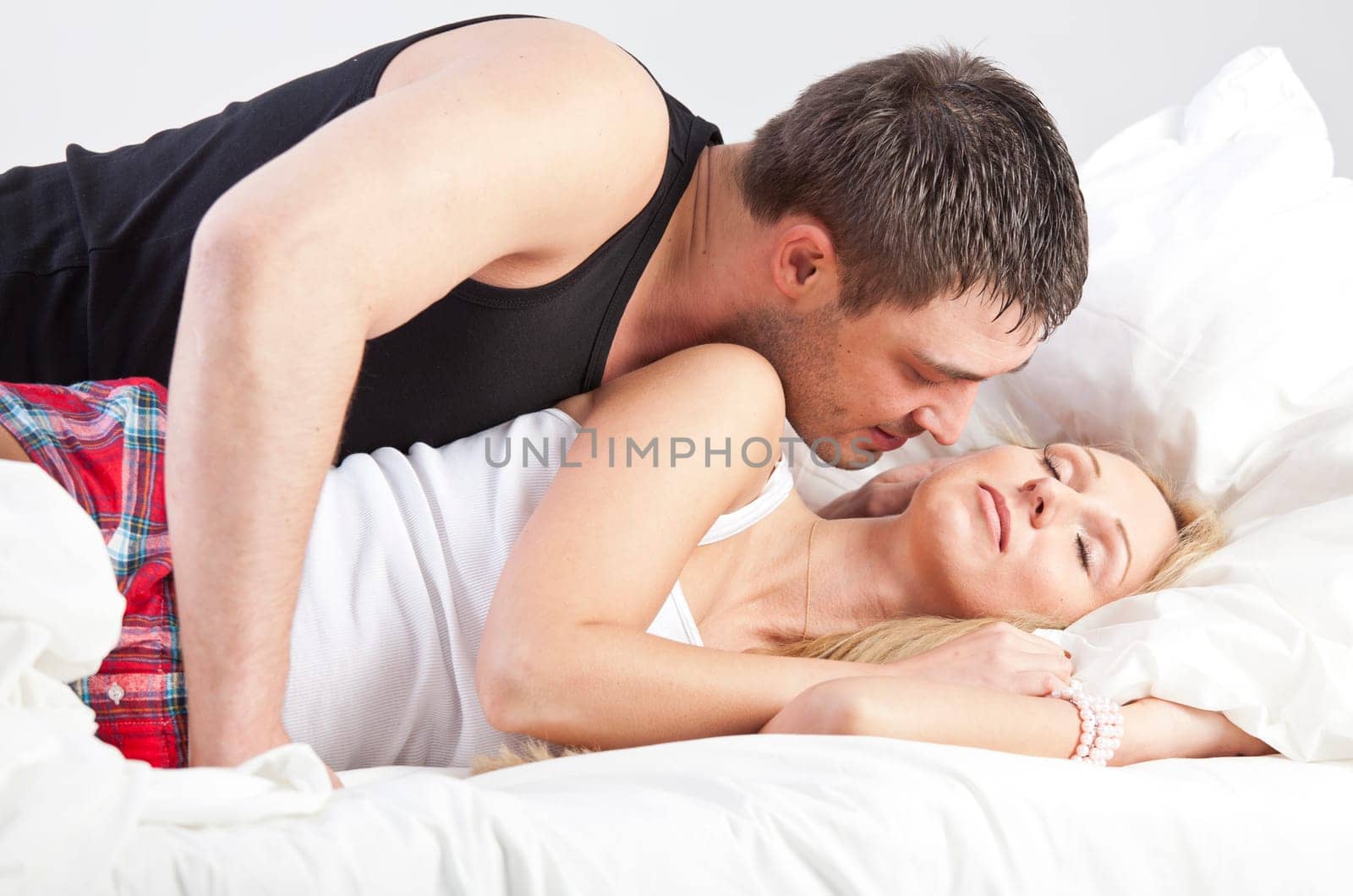 Couple in Love - man kissing sleeping woman