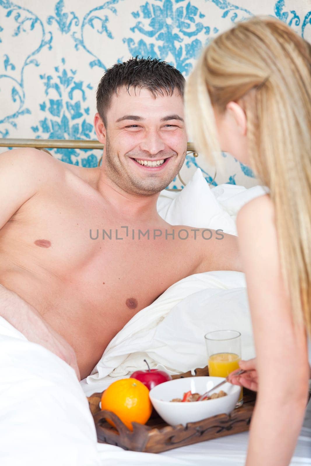 happy couple with breakfast in bed