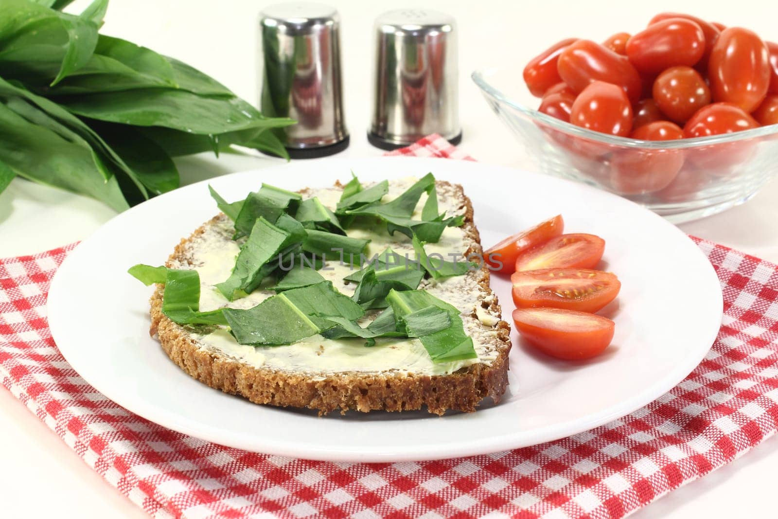 a slice of wholemeal bread with butter and wild garlic