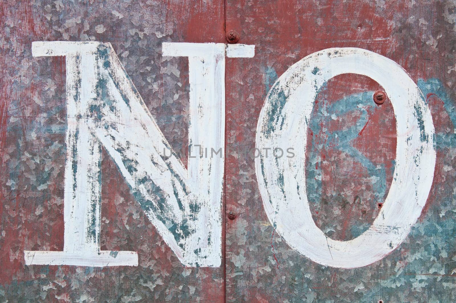 vintage word NO on a rusty red metallic surface