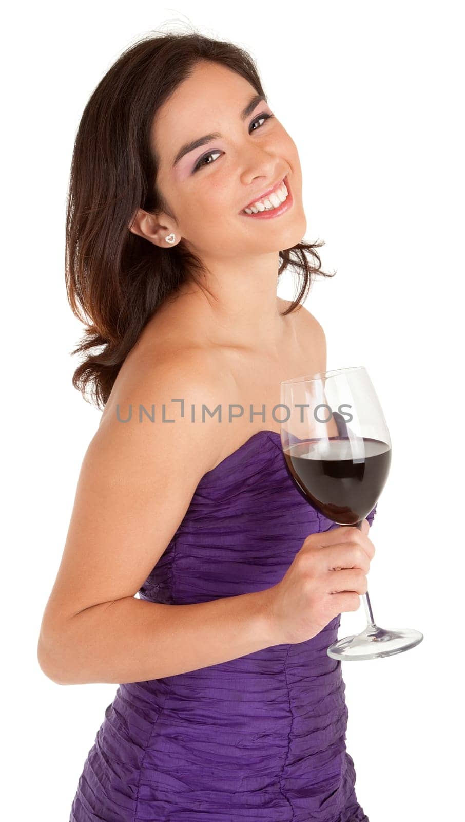 A beautiful woman in a classy dress is holding a glass of wine while smiling at the camera.
