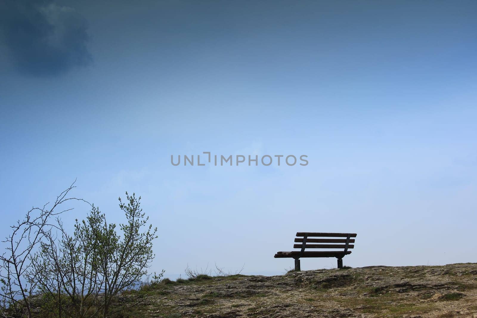 lonely bench on a rocky outcrop