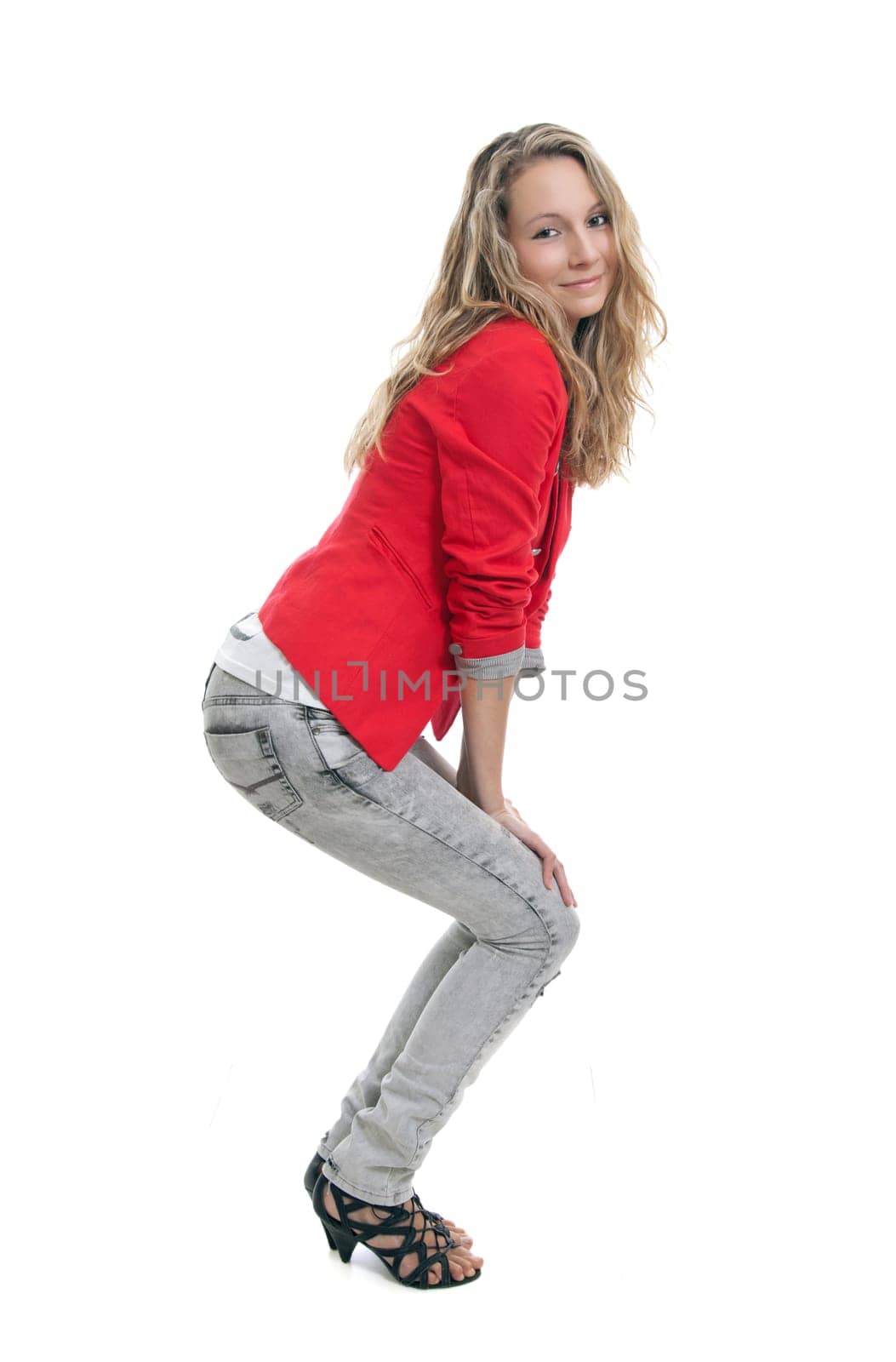 Full portrait of a young woman wearing jeans and red jacket
