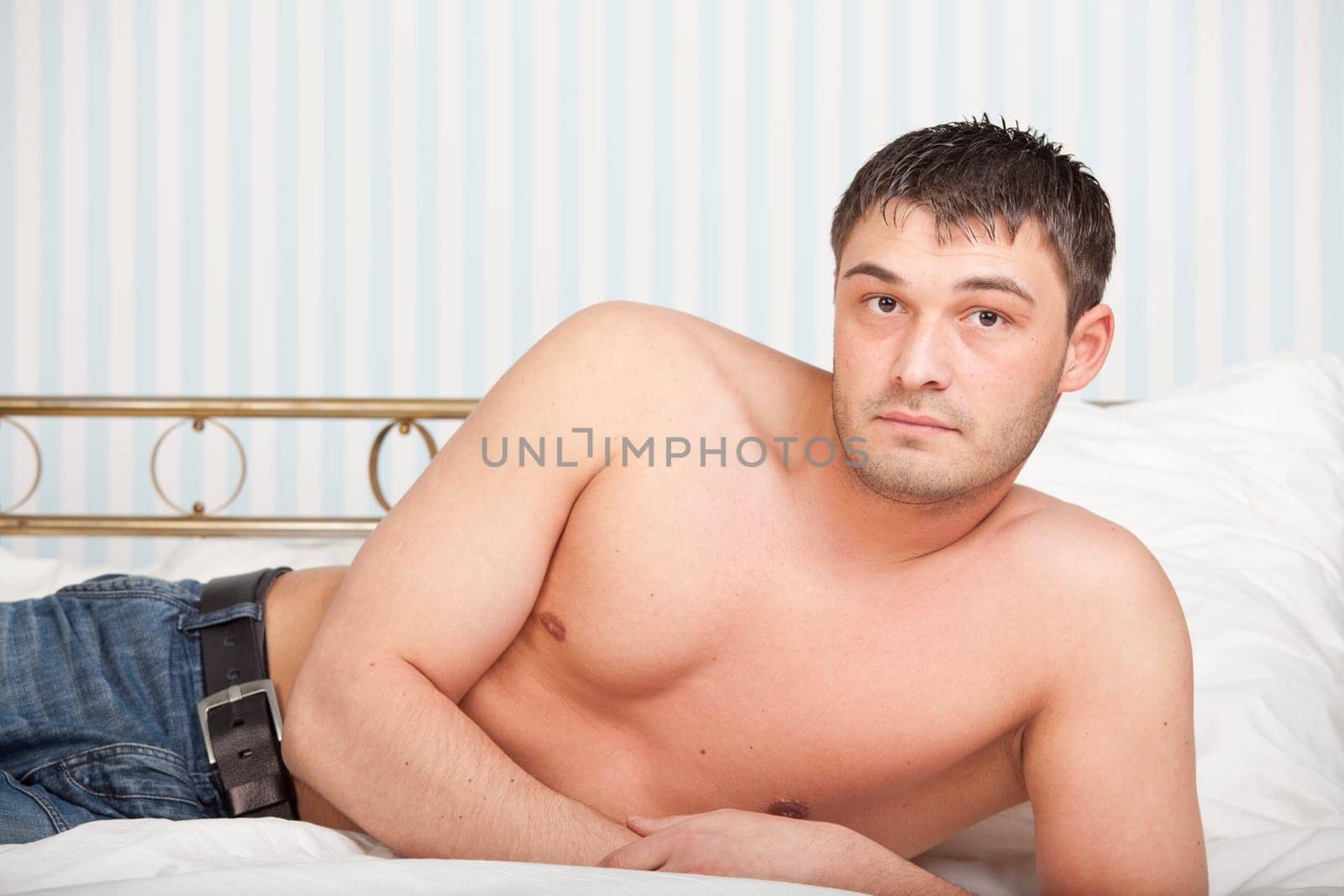 portrait of a man lying on the bed
