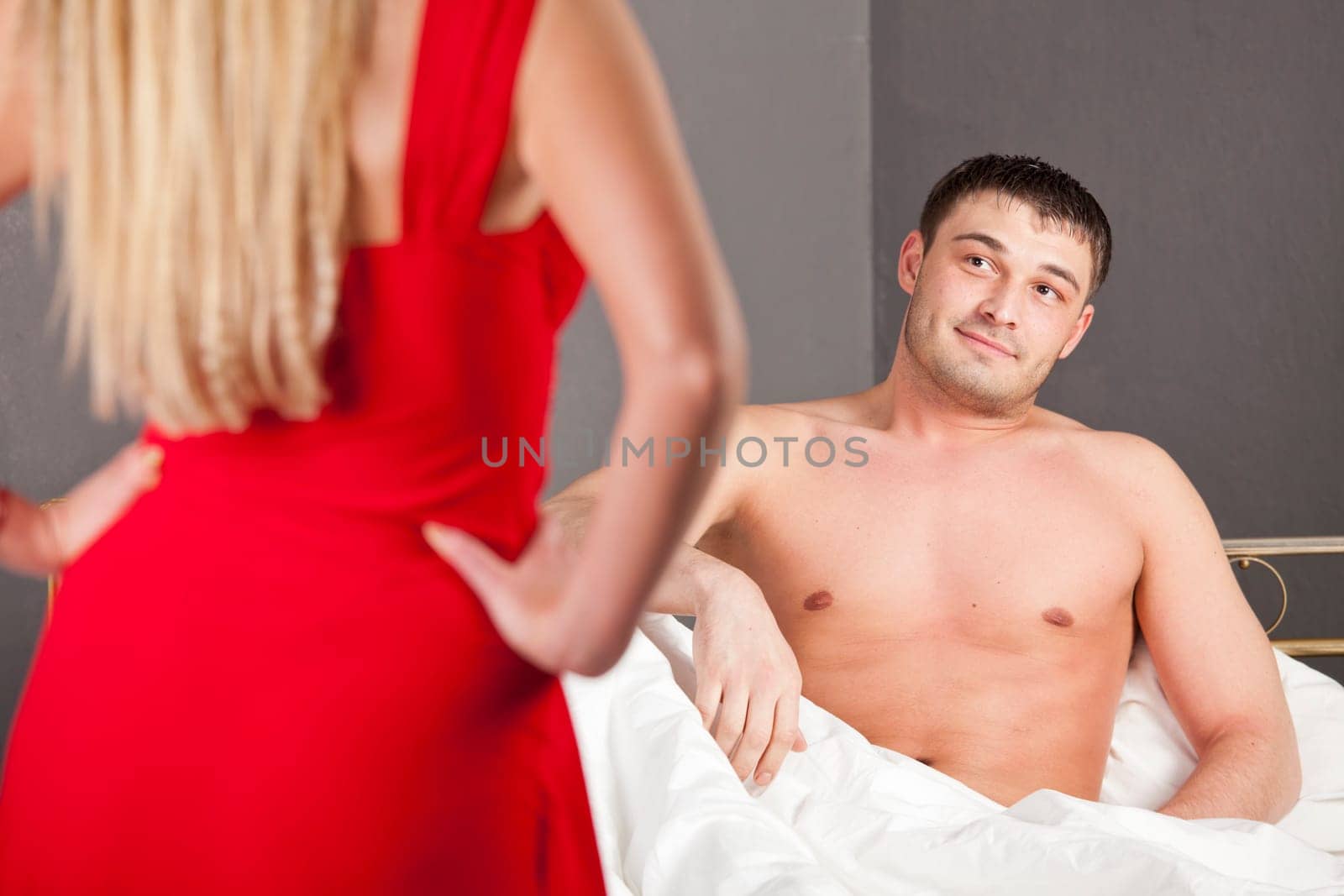 woman in red dress getting passionate with her husband
