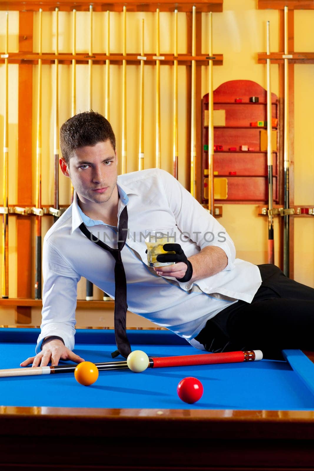 Billiard handsome player man drinking some alcohol in club