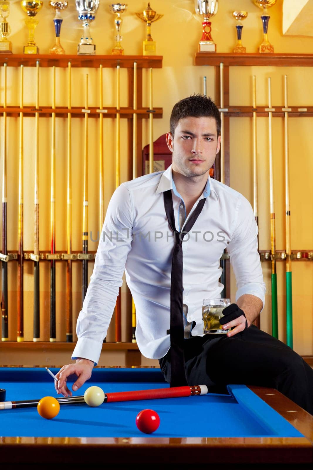 Billiard handsome player man drinking some alcohol in club