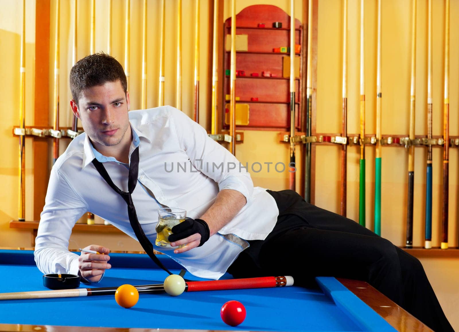 Billiard handsome player man drinking some alcohol in club