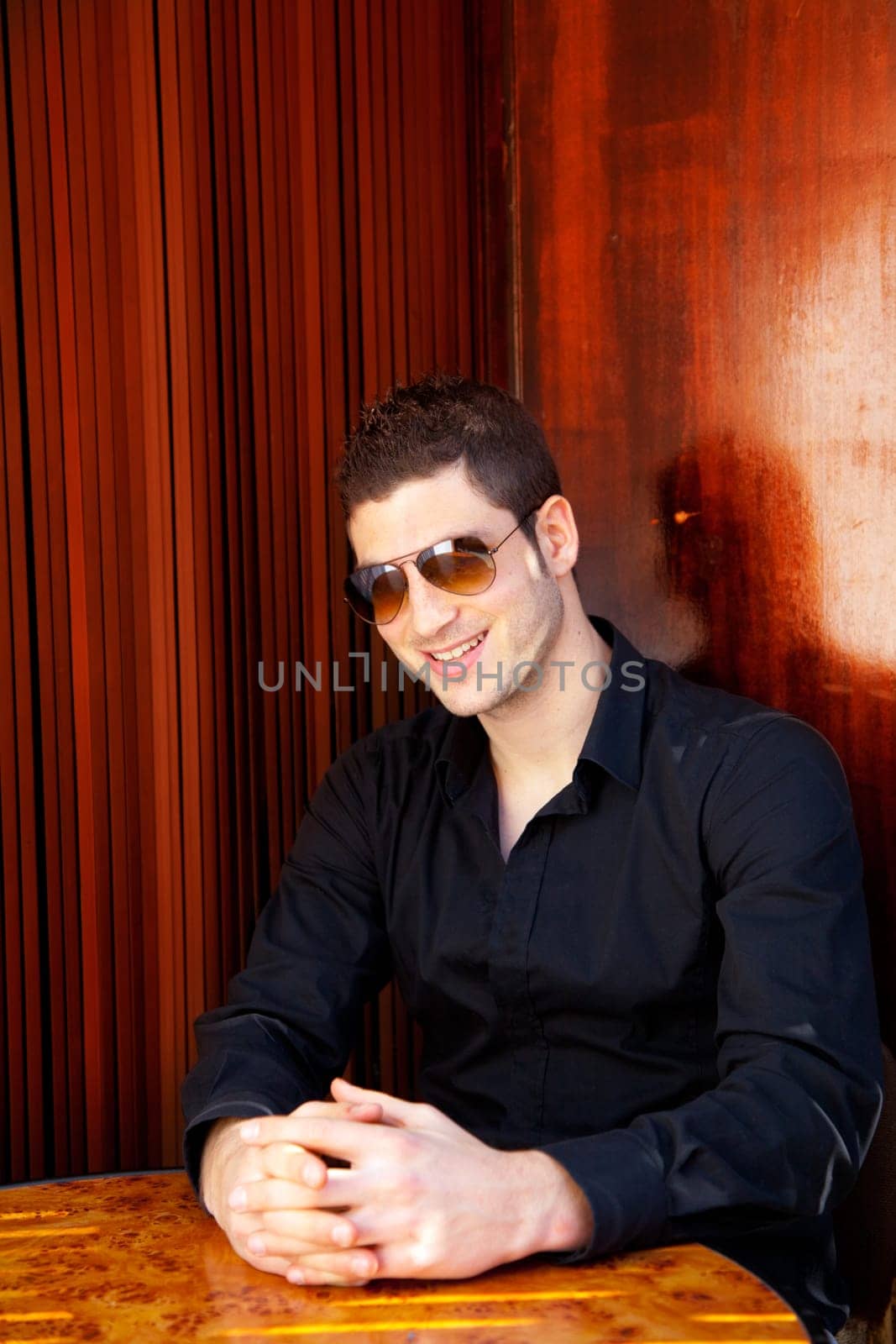 Latin mediterranean handsome man in wooden corner with sunglasses