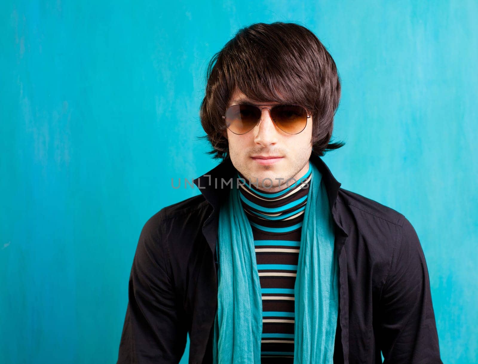 british indie pop rock look retro hip young man with sunglasses on blue