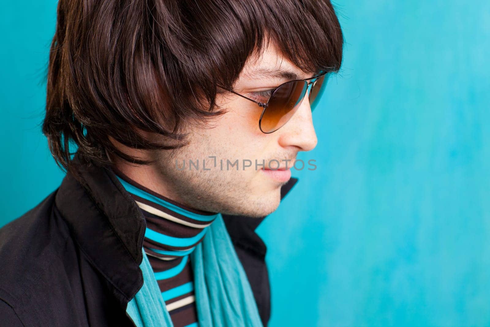 british indie pop rock look retro hip young man with sunglasses on blue