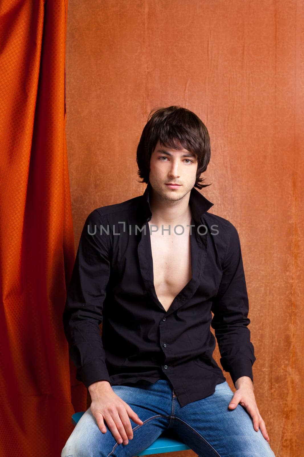 british indie pop rock look young man on orange brown retro background