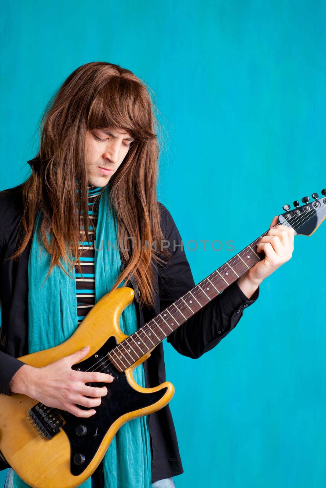 Hard rock seventies electric guitar player man with long hair