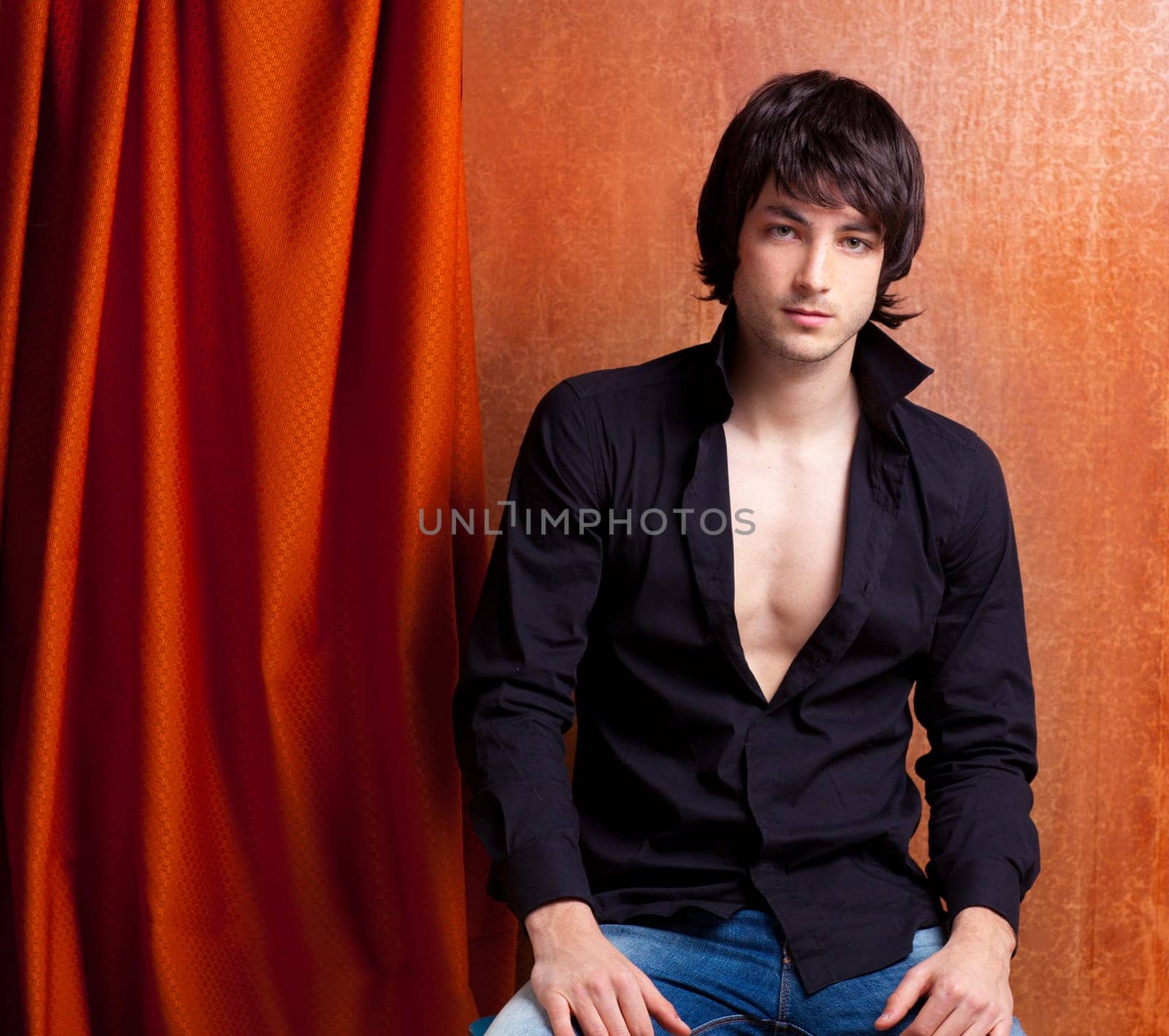 british indie pop rock look young man on orange brown retro background