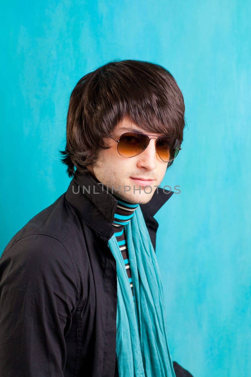 british indie pop rock look retro hip young man with sunglasses on blue