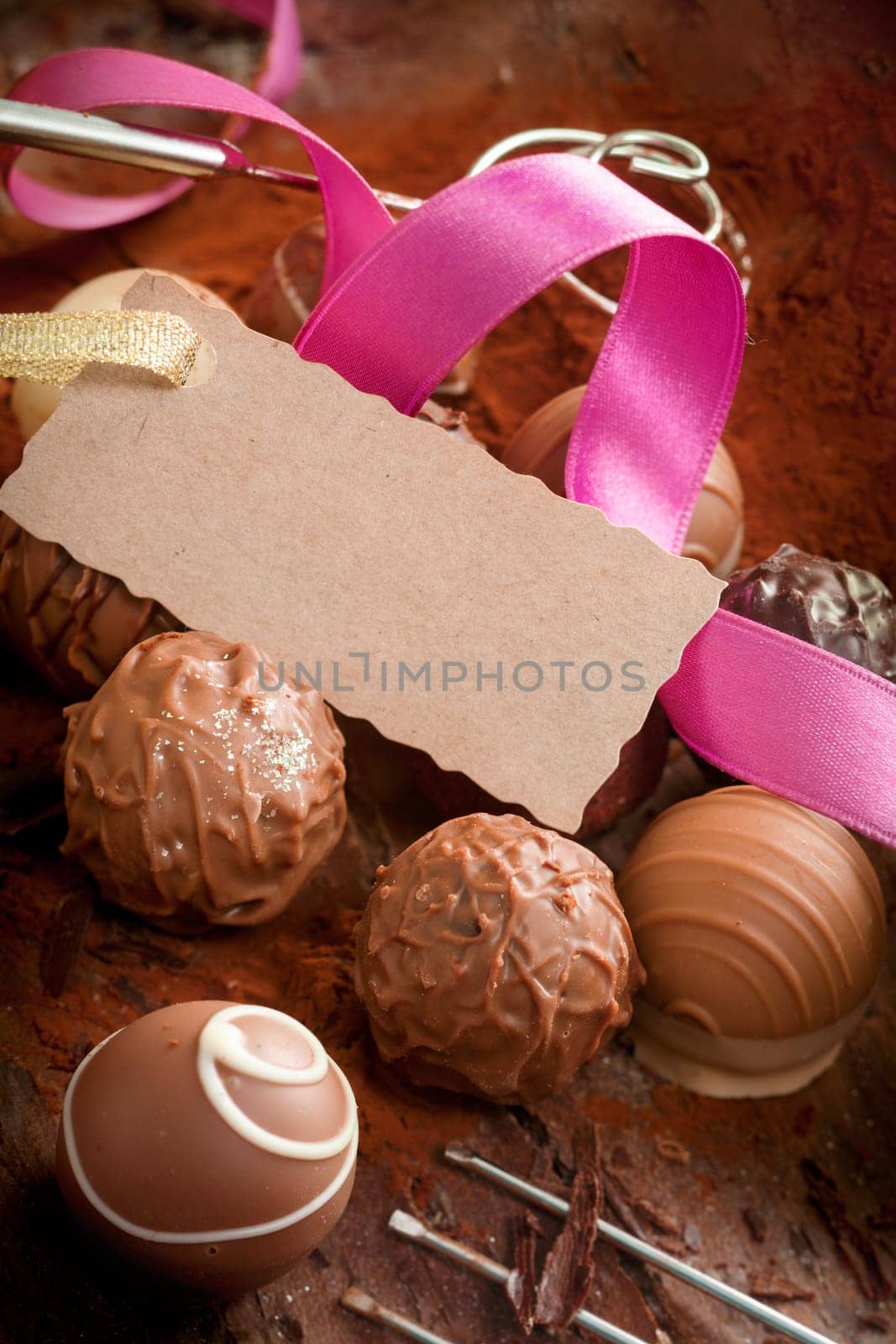 Handmade gourmet chocolates with a decorative pink ribbon and a luxury testured blank gift tag with a serrated edge