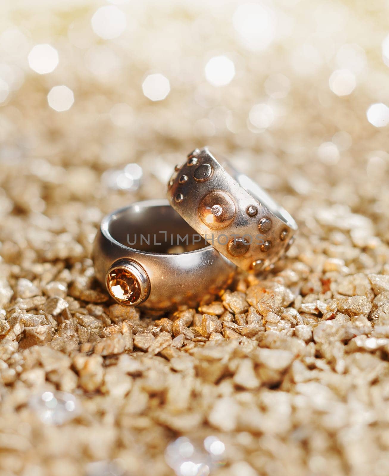 Two Rings with jewels on a golden background maybe for a wedding card