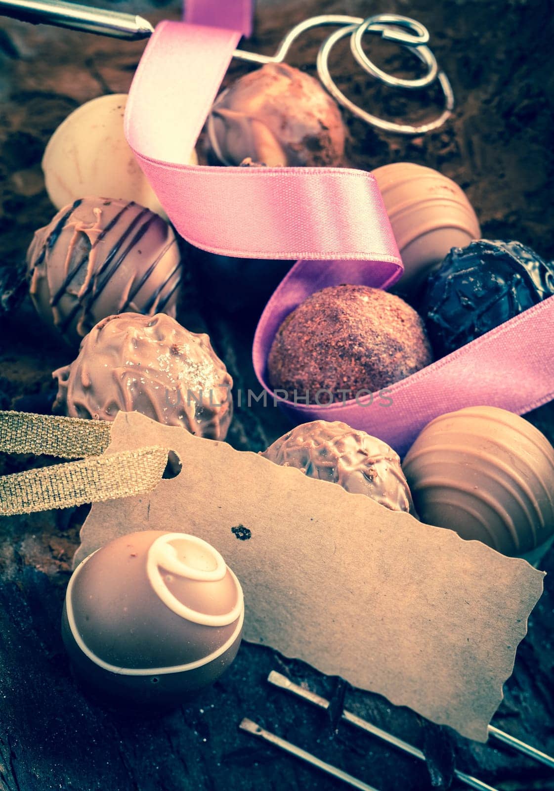 Vintage pralines with a place card on wooden background