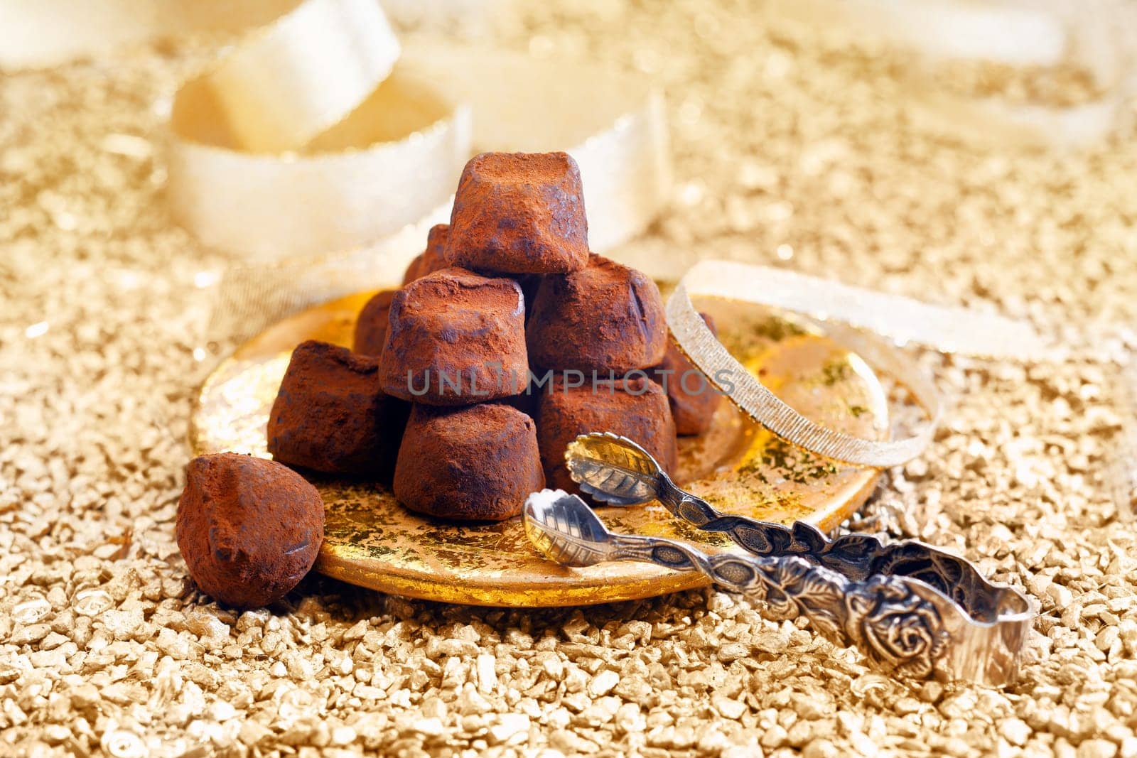 chocolate candy pralines with golden background for a festive holiday concept