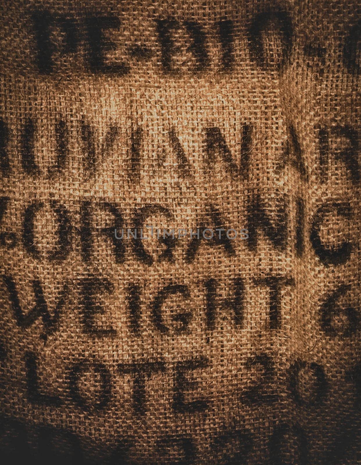 Vertical background of a twenty kilogram hessian coffee bag stamped and certified one hundred percent organic