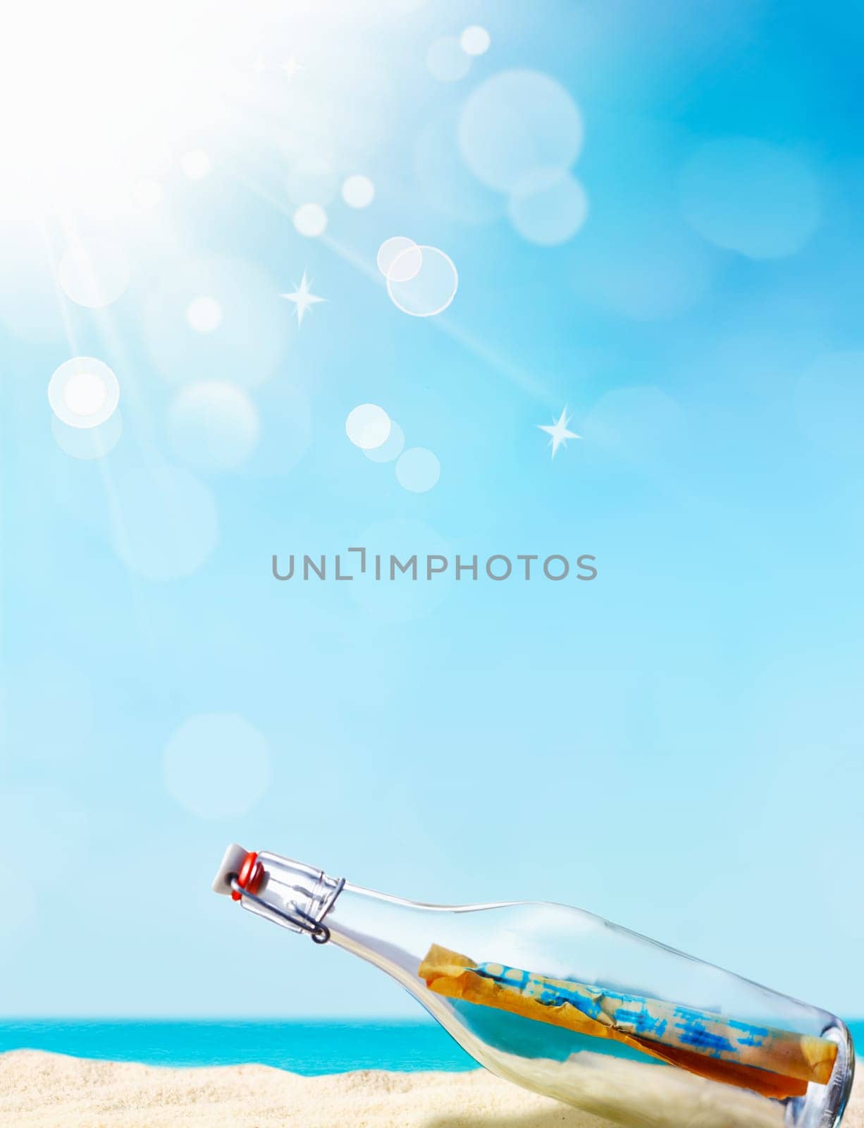 Message in a bottle illustrated with a beautiful sand beach in the background and a blue sky with awesome bokeh, maybe for your individual summer concept