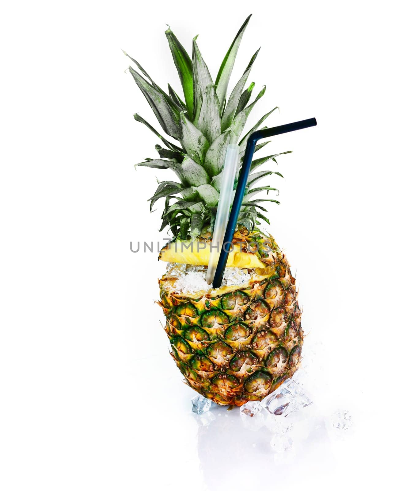 Fresh pineapple with ice and tubules isolated on white. Tropical cocktail
