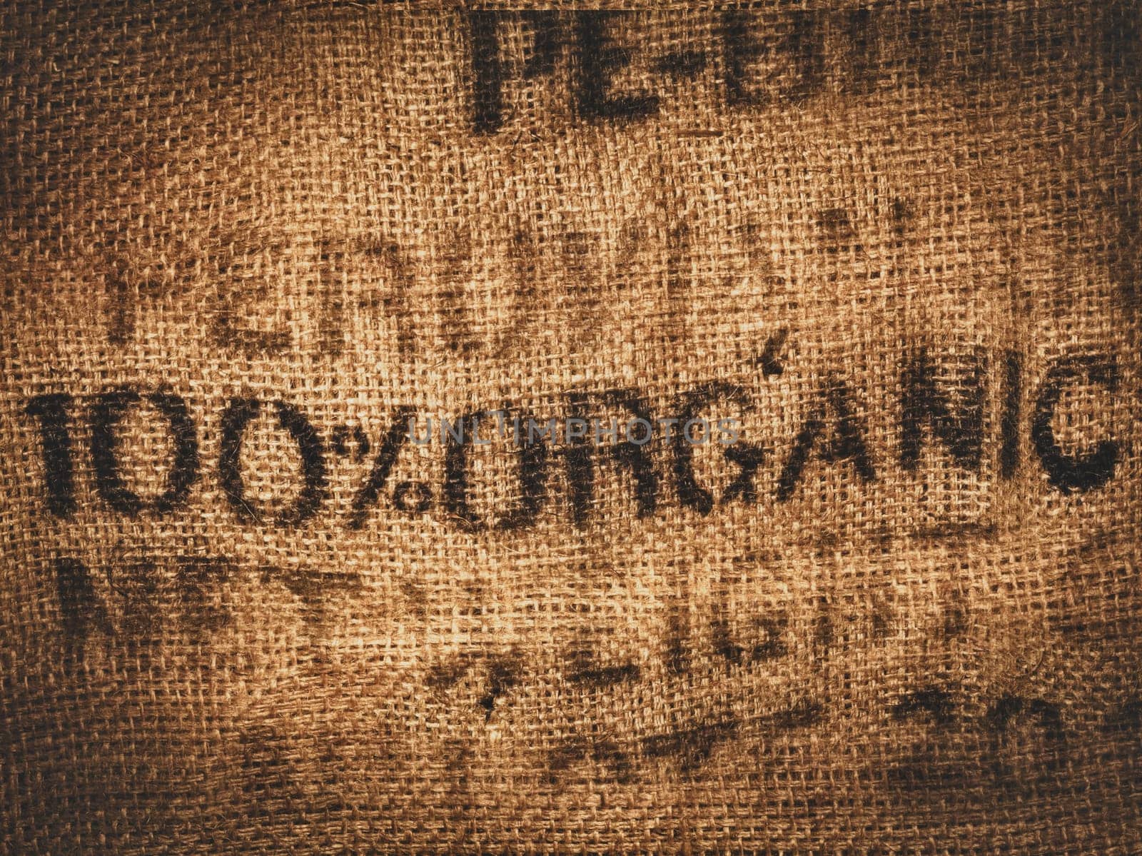 Background of a hessian coffee bag stamped and certified one hundred percent organic