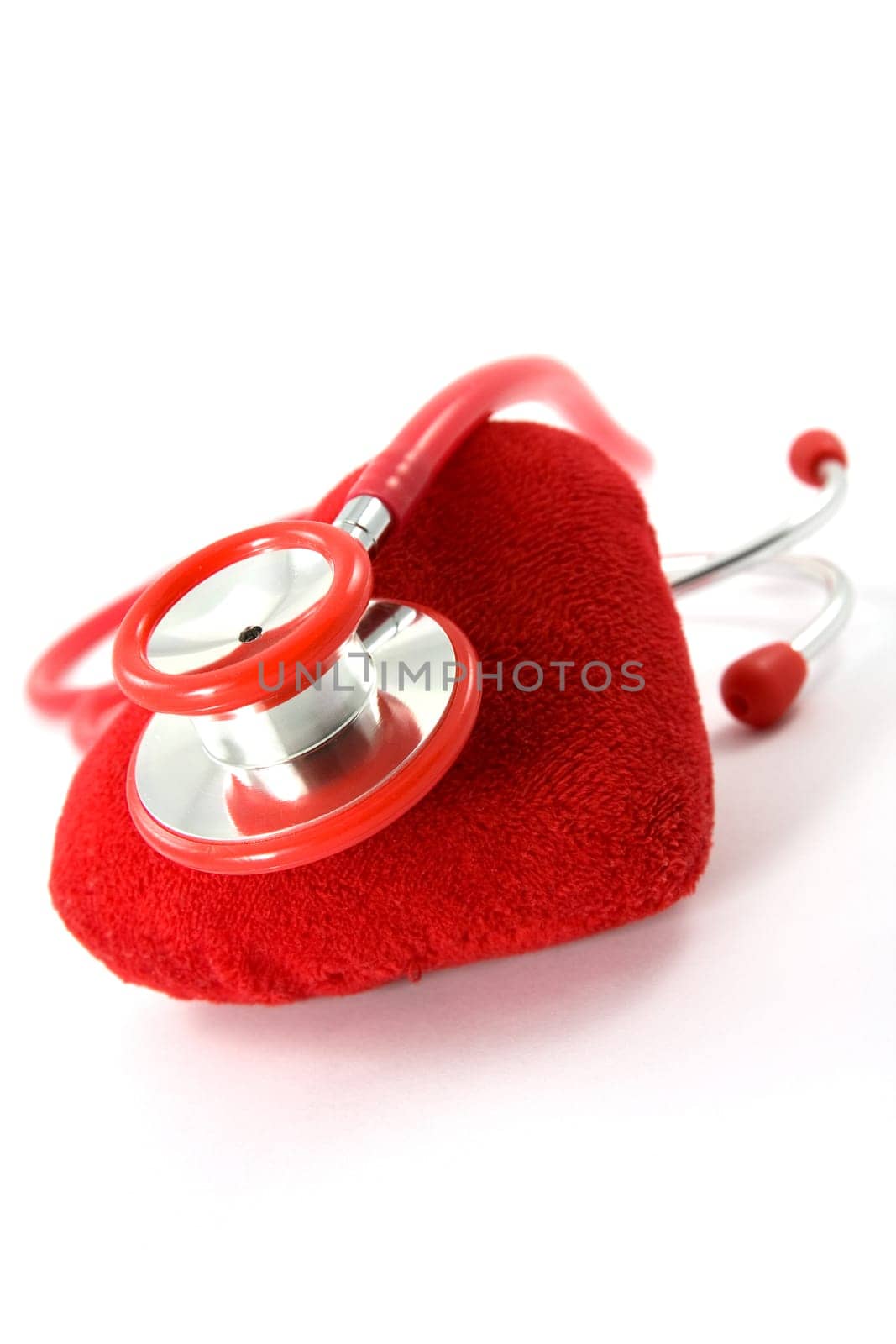 Heart and a stethoscope on white background
