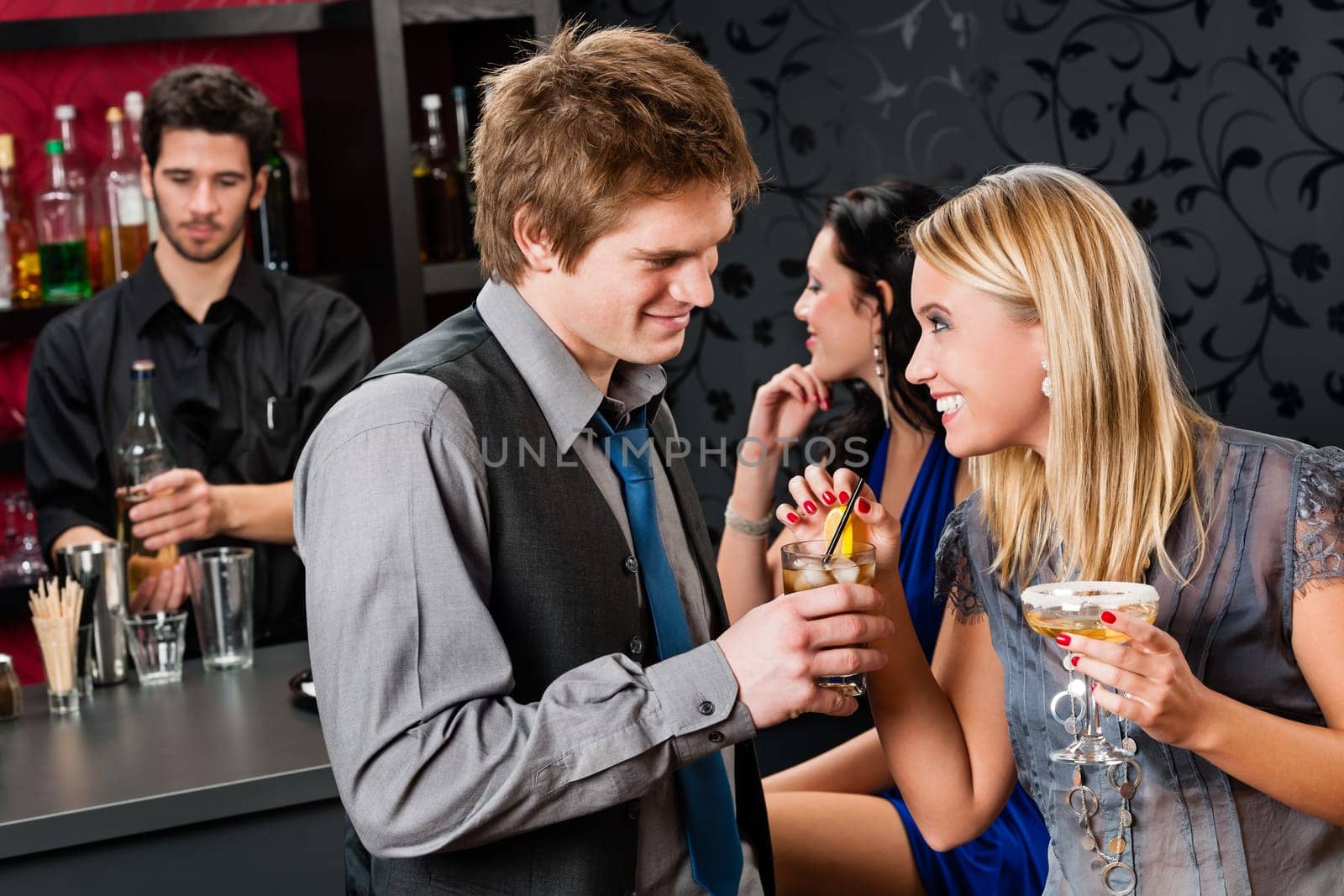 Cocktail bar young happy friends enjoy drinks