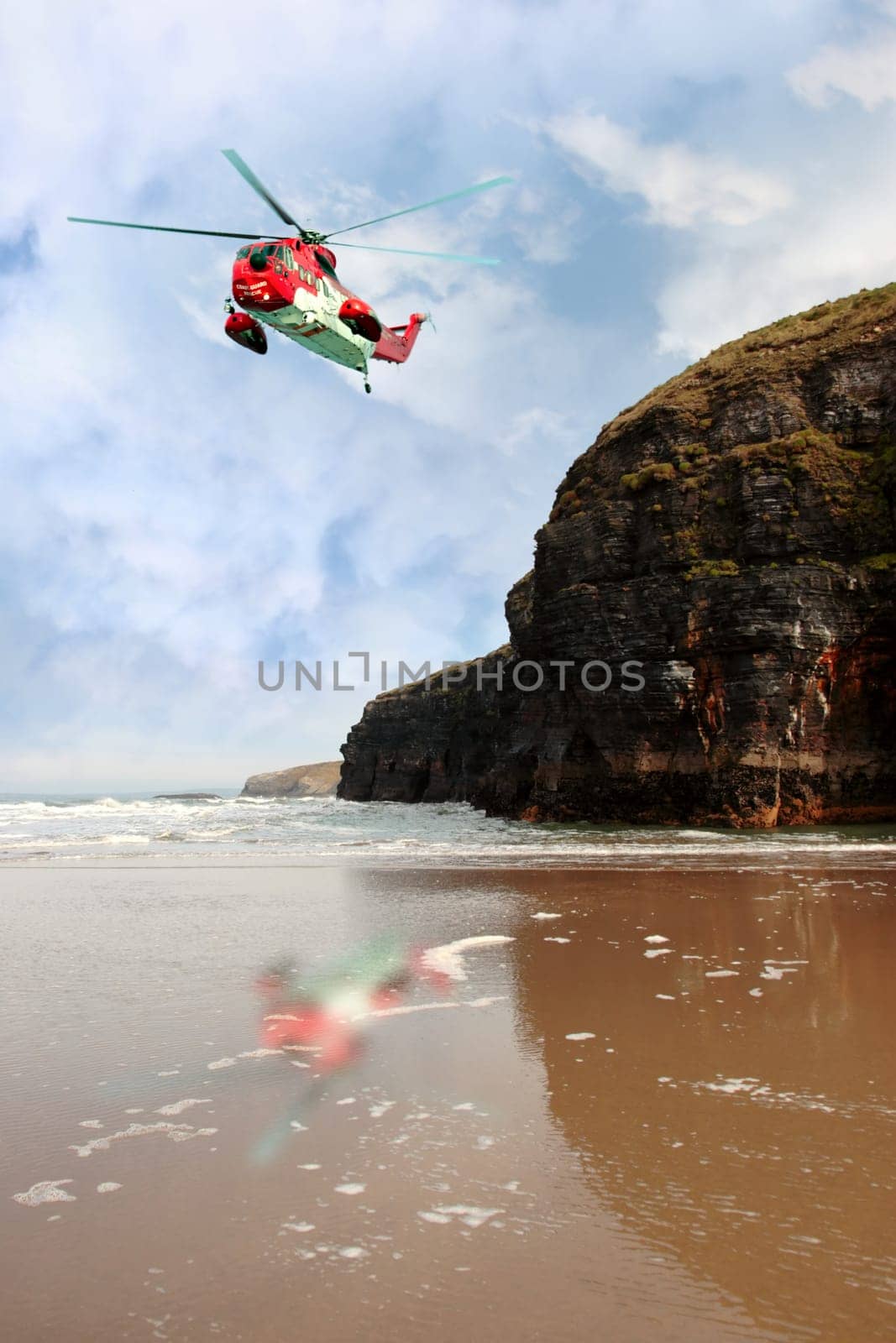 a sea rescue helicopter searching for person near to the cliffs on search and rescue mission in ballybunion county kerry ireland