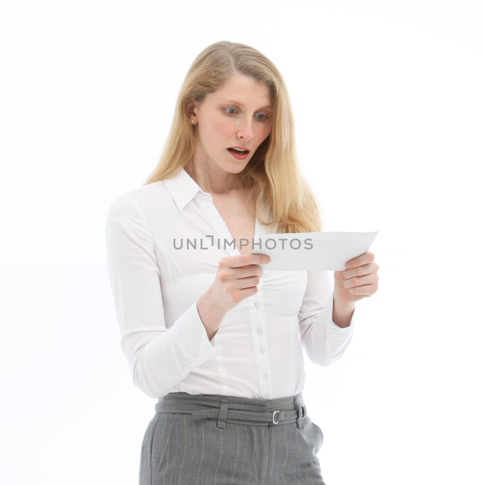 Young woman looking at an envelope in surprise and horror against a white background -Square