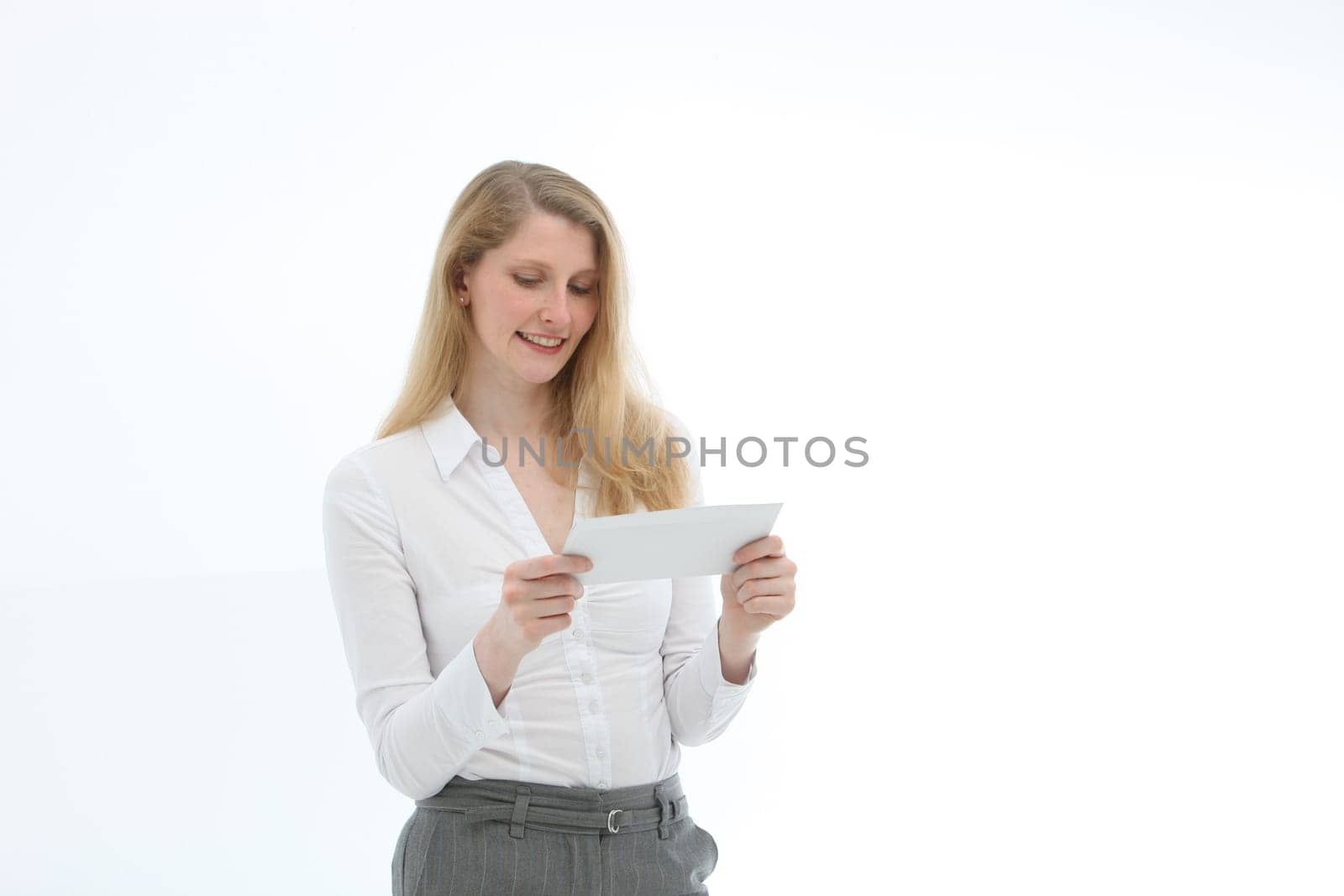 Young woman receives good news. She looks at a letter clipping with text space