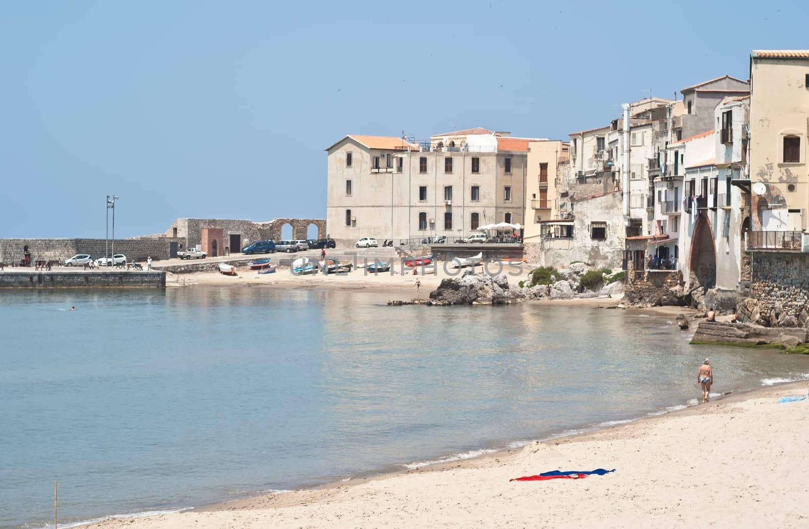 Cefalu Beach with old buildings and clear  blue sky. Sicily