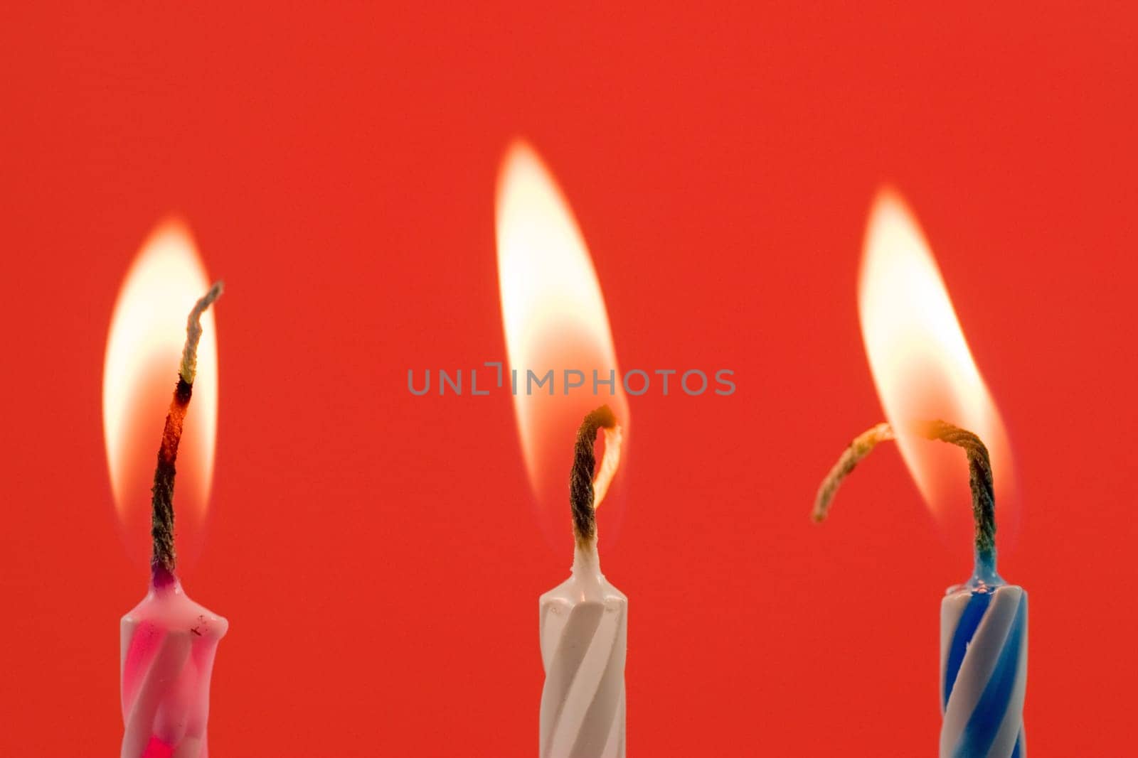 birthday candles , isolated over a red background