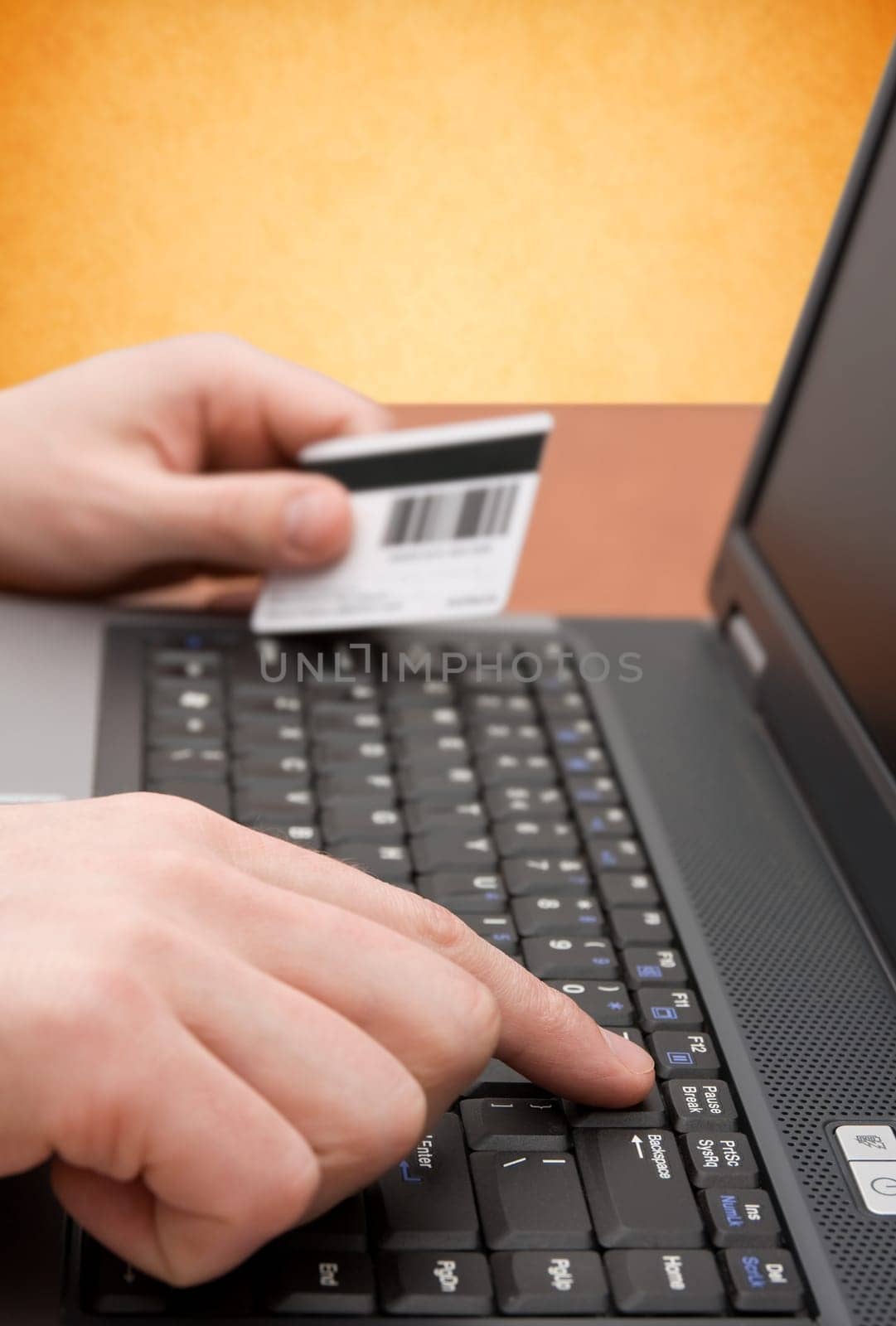 e-commerce concept. hands with credit card on computer keyboard
