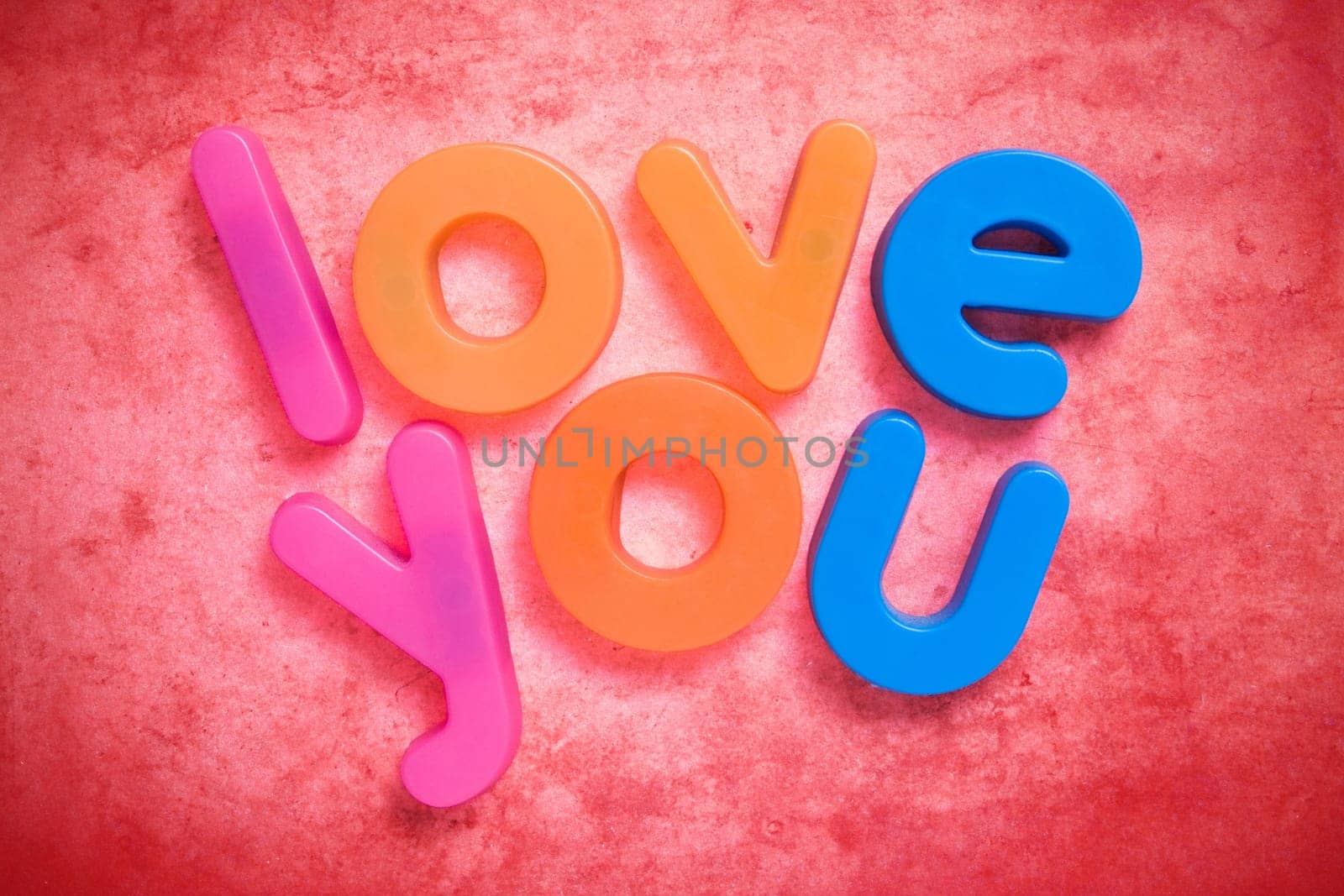 the words "love you"" written with colorful letter magnets"