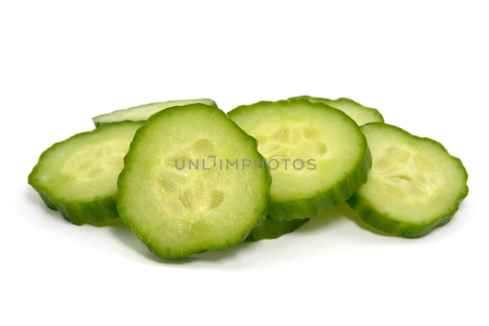 green cucumber slices over a white background