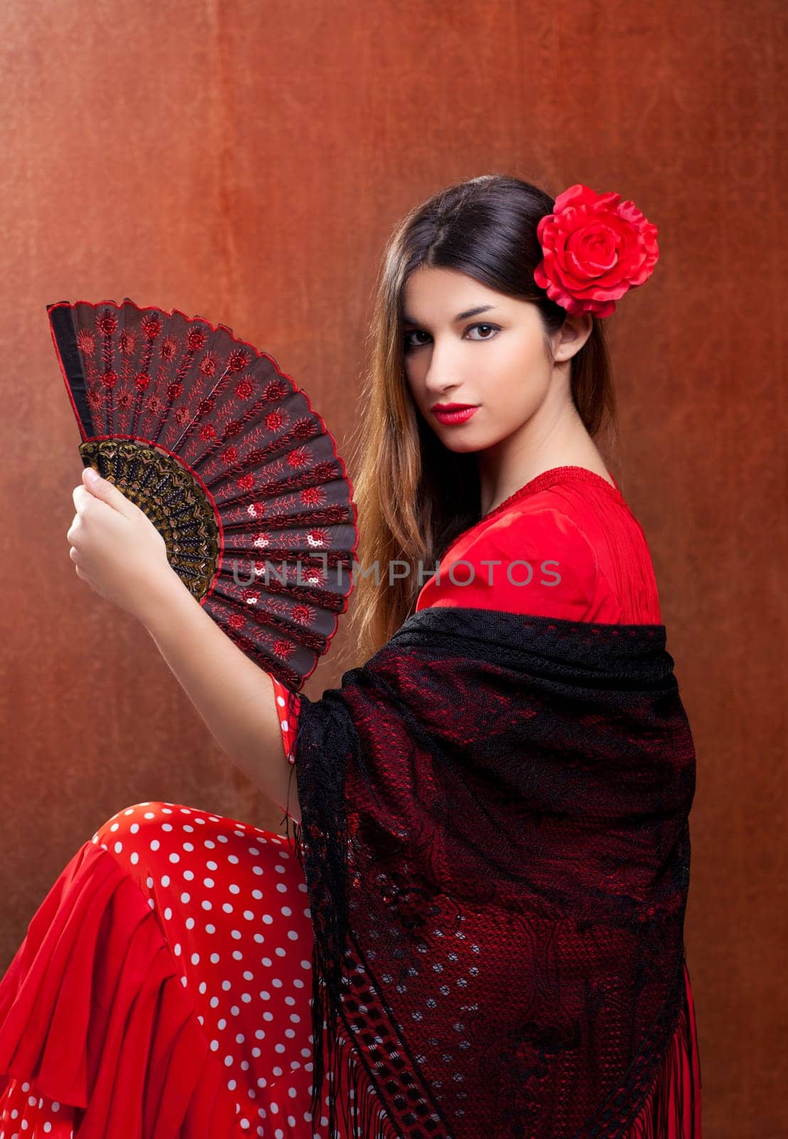 Gipsy flamenco dancer Spain girl with red rose and spanish hand fan