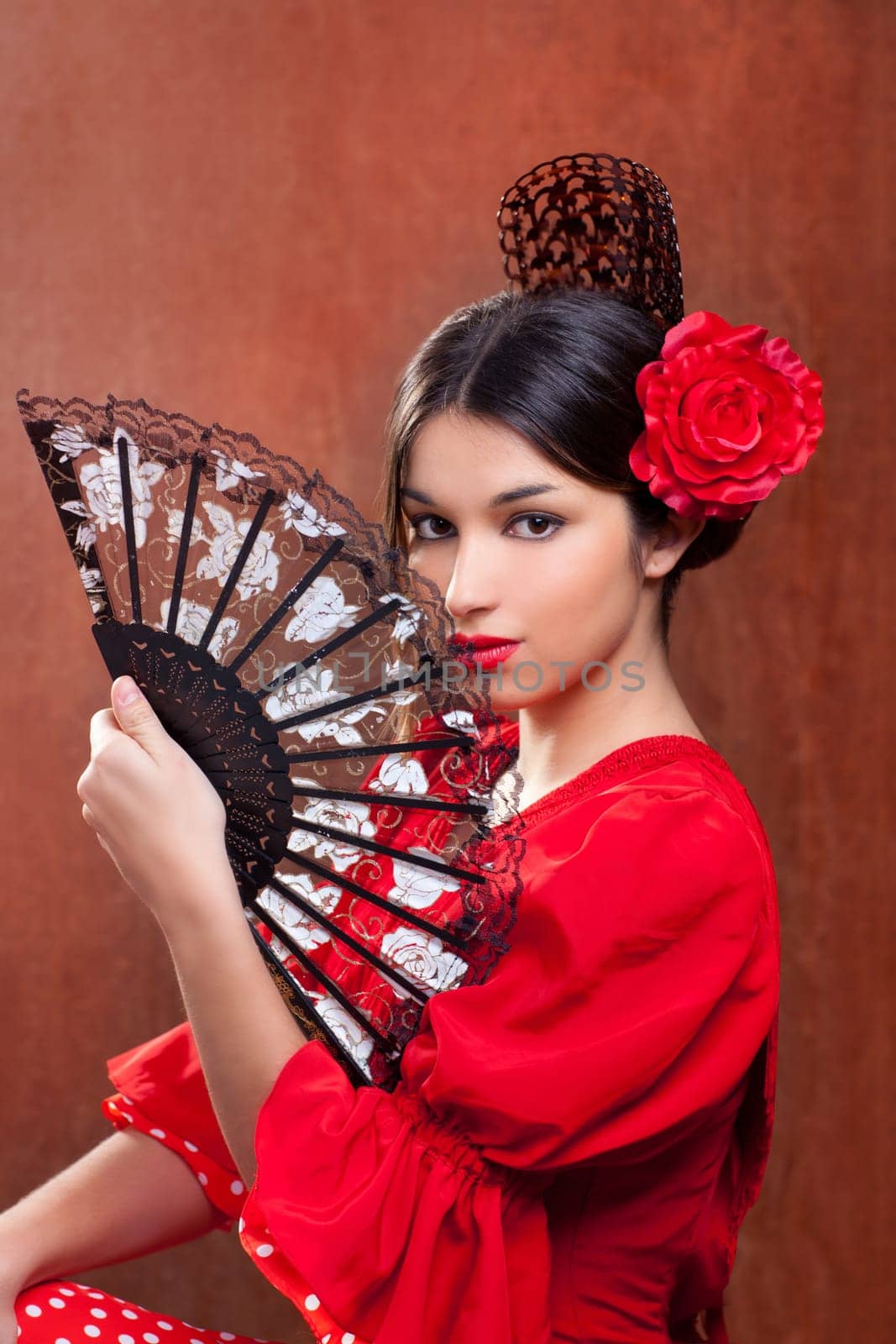 Gypsy flamenco dancer Spain girl with red rose spanish hand fan and peineta comb