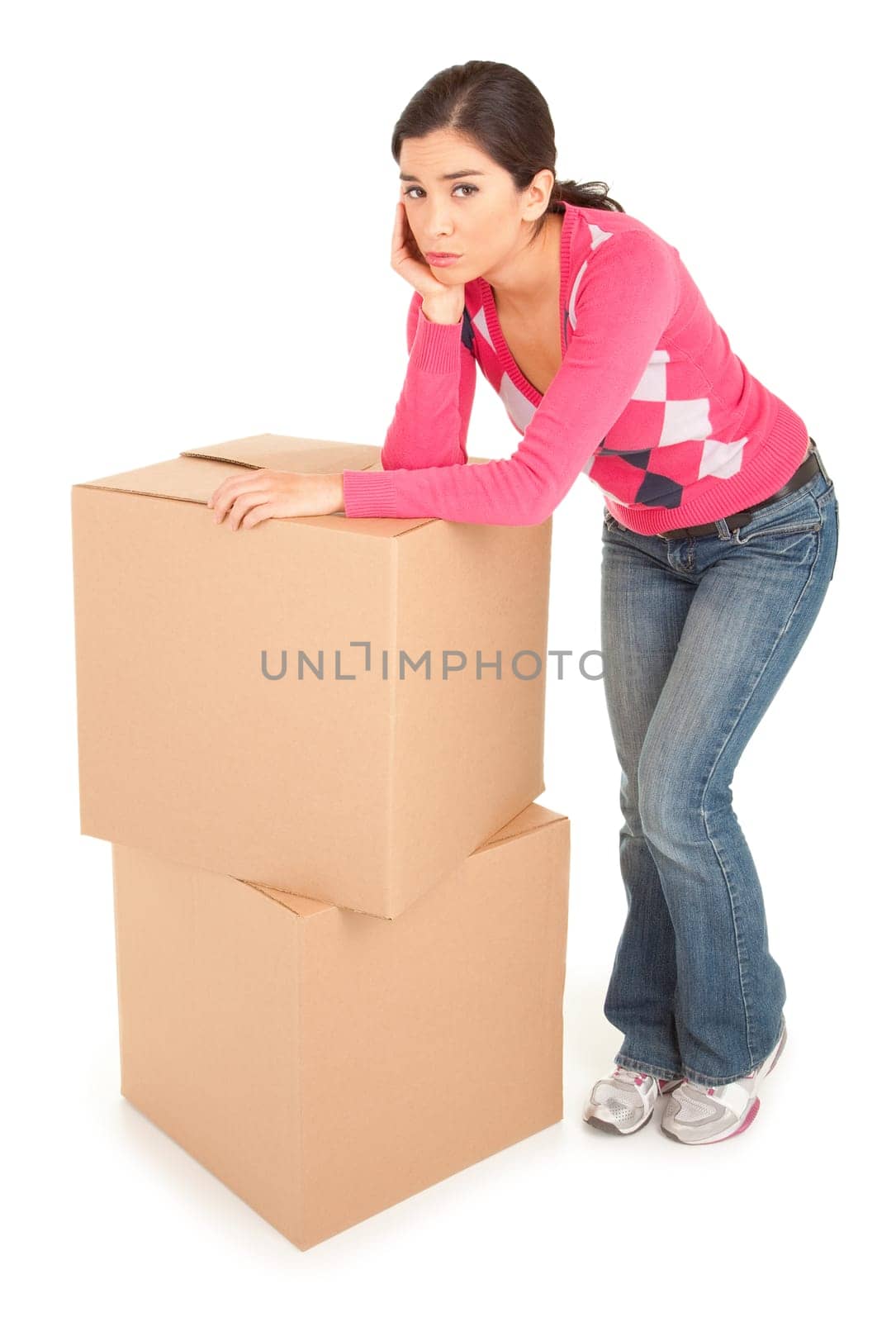 A tired looking woman is leaning on cardboard boxes.