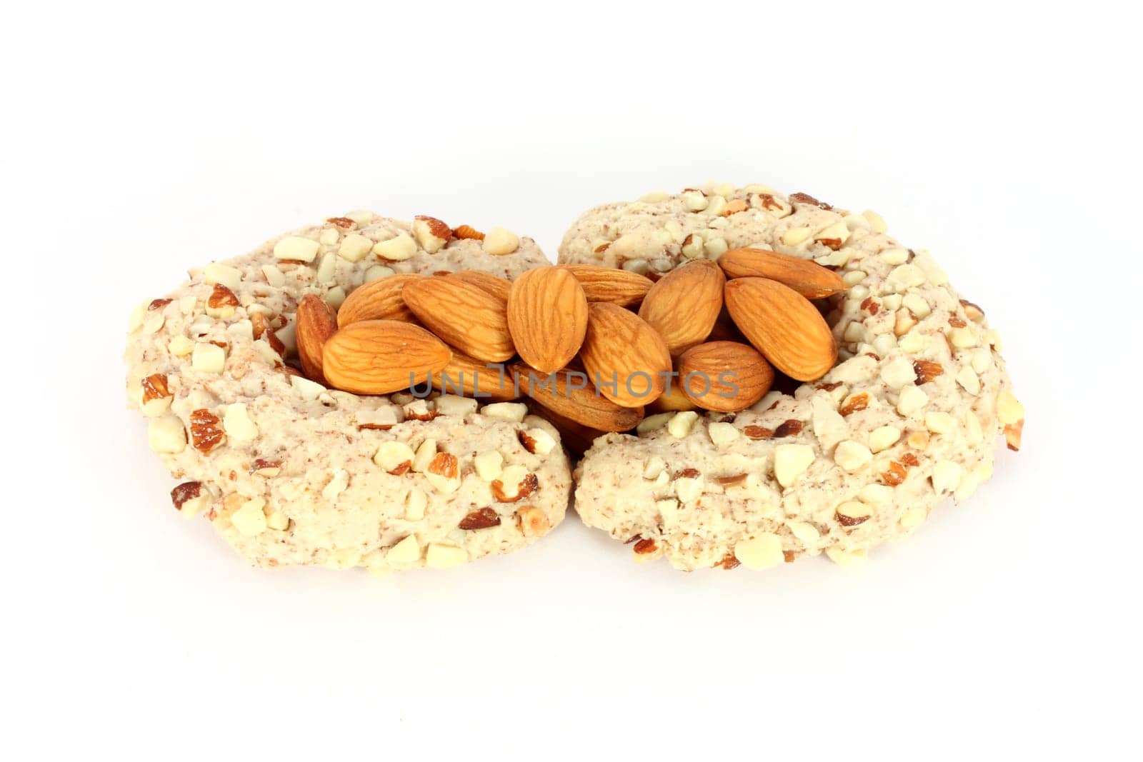 Homemade cakes in shape of crescent with some almonds, isolated on white
