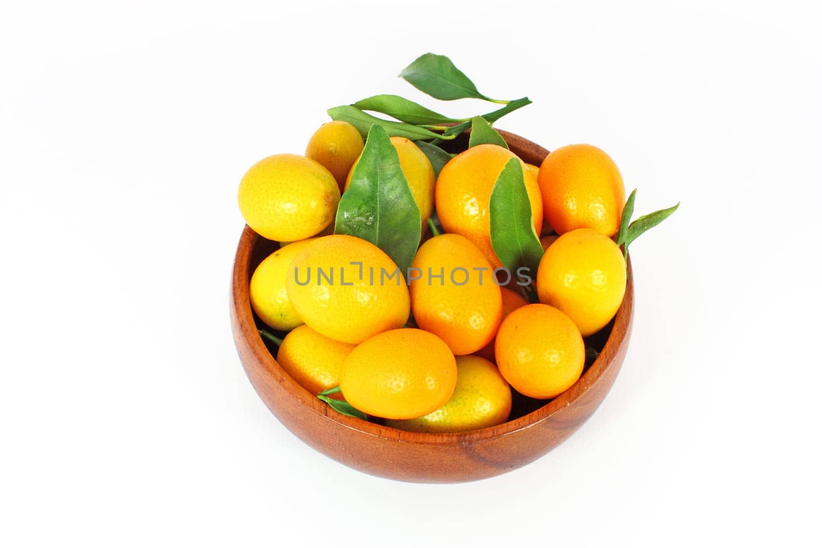 kumquat midget orange in wooden bowl isolated on white